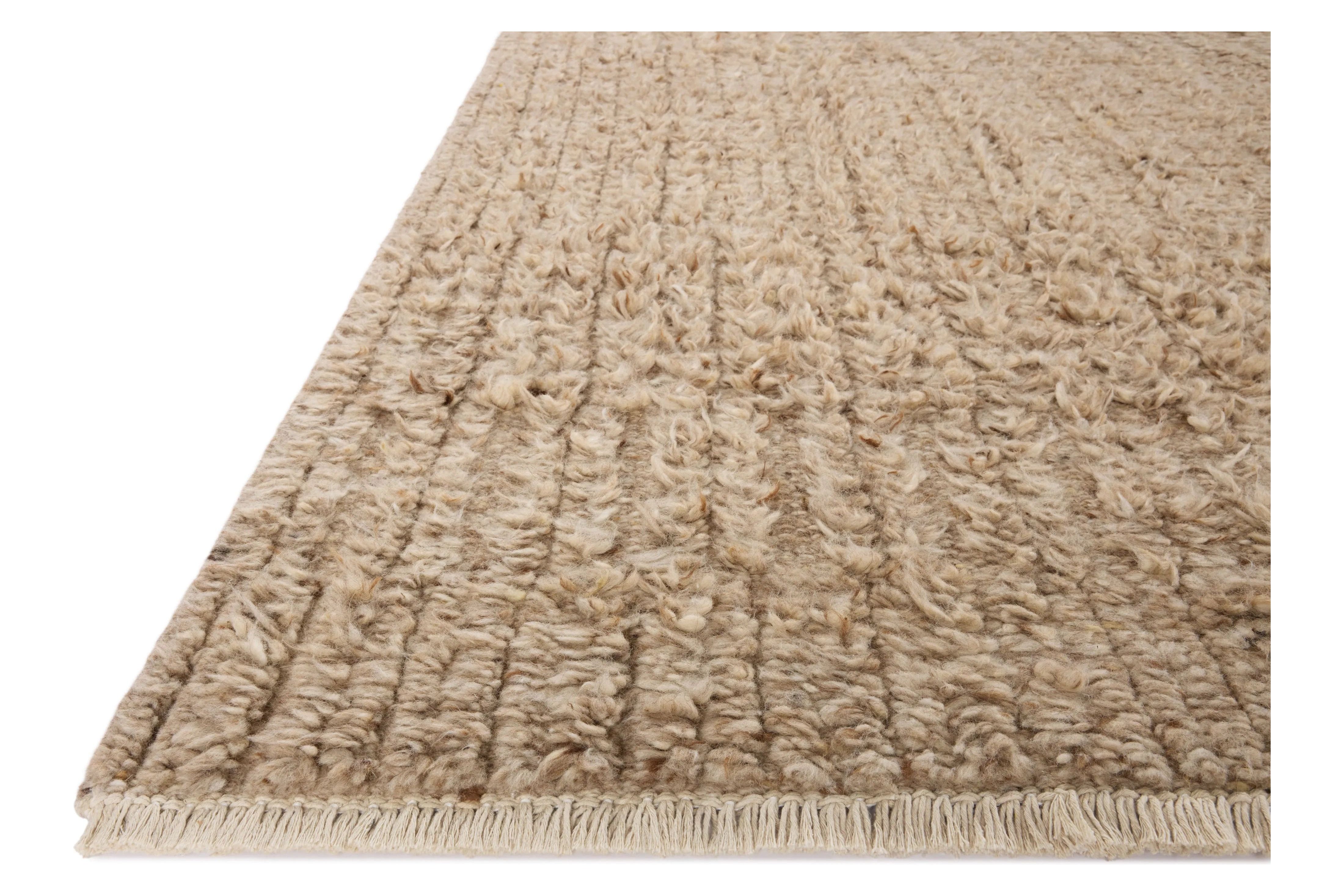 Irresistible to walk upon, the Dana Sand Rug by Brigette Romanek x Loloi has a high-low texture that alternates between a subtly shaggy pile and a soft base. Horizontal broken stripes give the area rug a fresh and energized structure, while a finish of fringe along the edges accentuates its sense of movement. Amethyst Home provides interior design, new home construction design consulting, vintage area rugs, and lighting in the Newport Beach metro area.