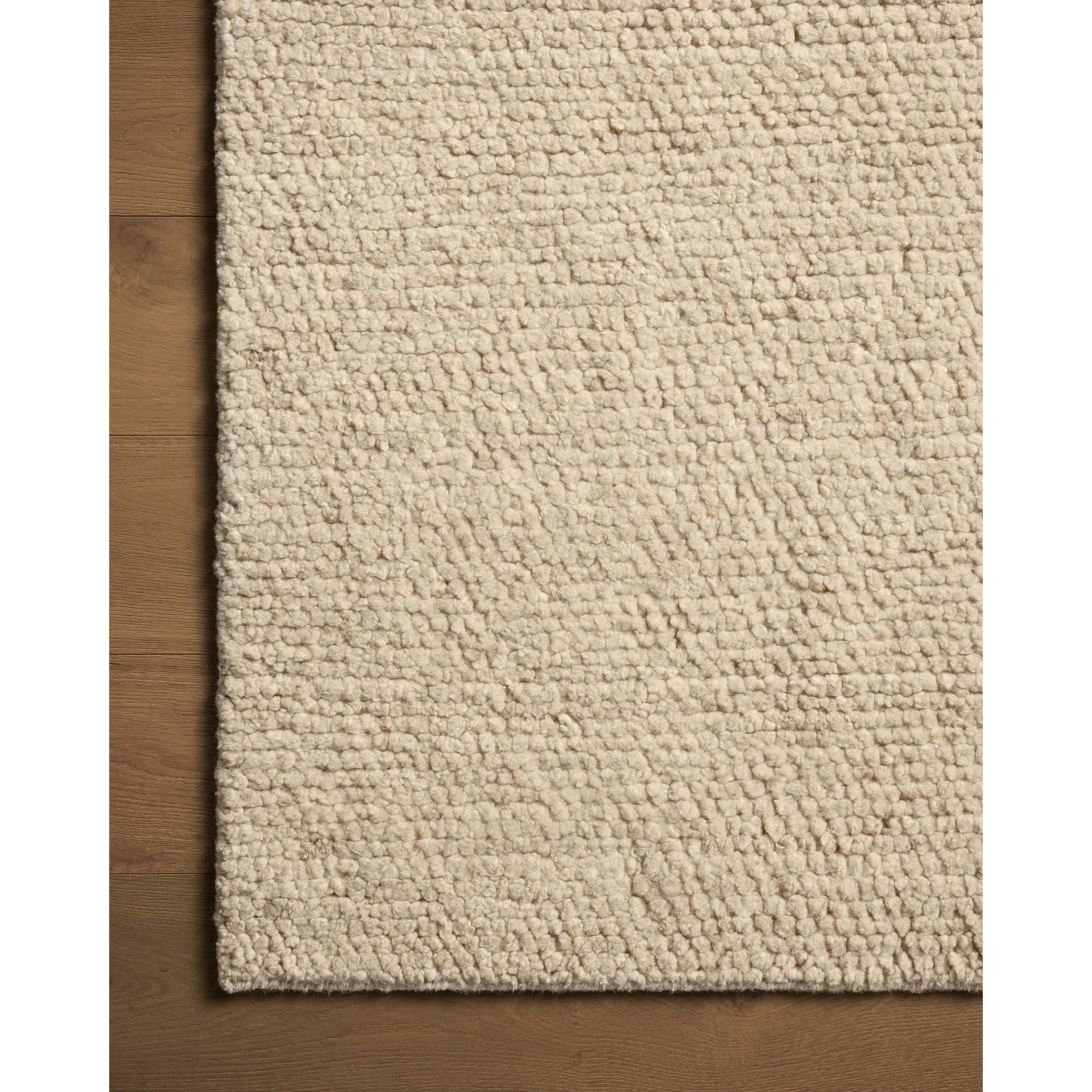 With versatile earth tones and a chunky, hand-knotted texture resembling tiny pebbles, the Frida Bone Rug by Brigette Romanek x Loloi can ground any room with a sense of elevated ease. Each area rug features a subtle nuance in color variation due to the handmade nature of its construction and has a pleasantly nubby softness underfoot. Amethyst Home provides interior design, new home construction design consulting, vintage area rugs, and lighting in the Dallas metro area.