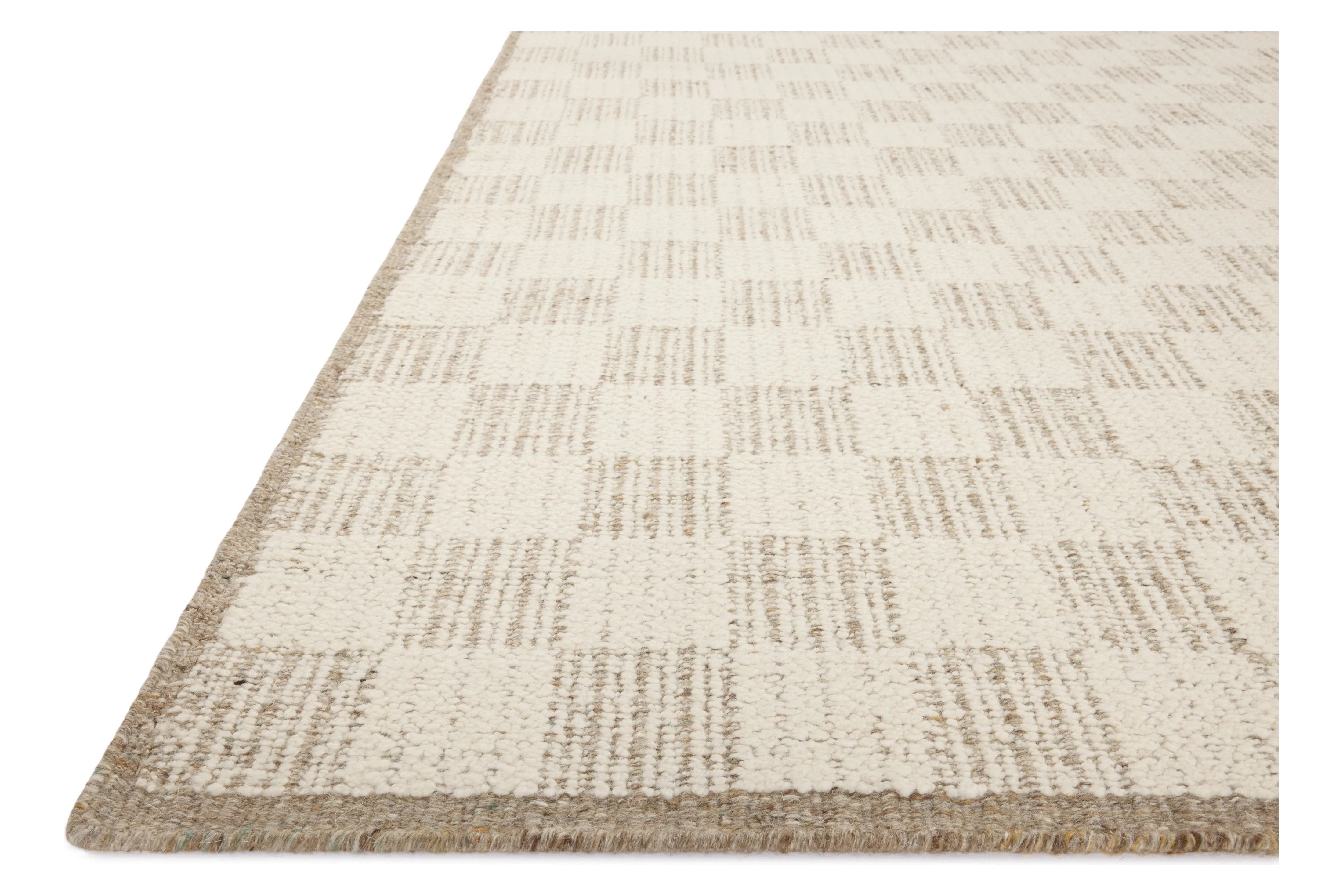 The Knox Ivory / Khaki Rug by Brigette Romanek x Loloi is a handwoven area rug with a contemporary checkerboard pattern and a texture reminiscent of a luxurious knit sweater. Made of a blend of wool and cotton that plays with scale and texture, Knox is imbued with cozy luxury that can anchor any room. Amethyst Home provides interior design, new home construction design consulting, vintage area rugs, and lighting in the Miami metro area.