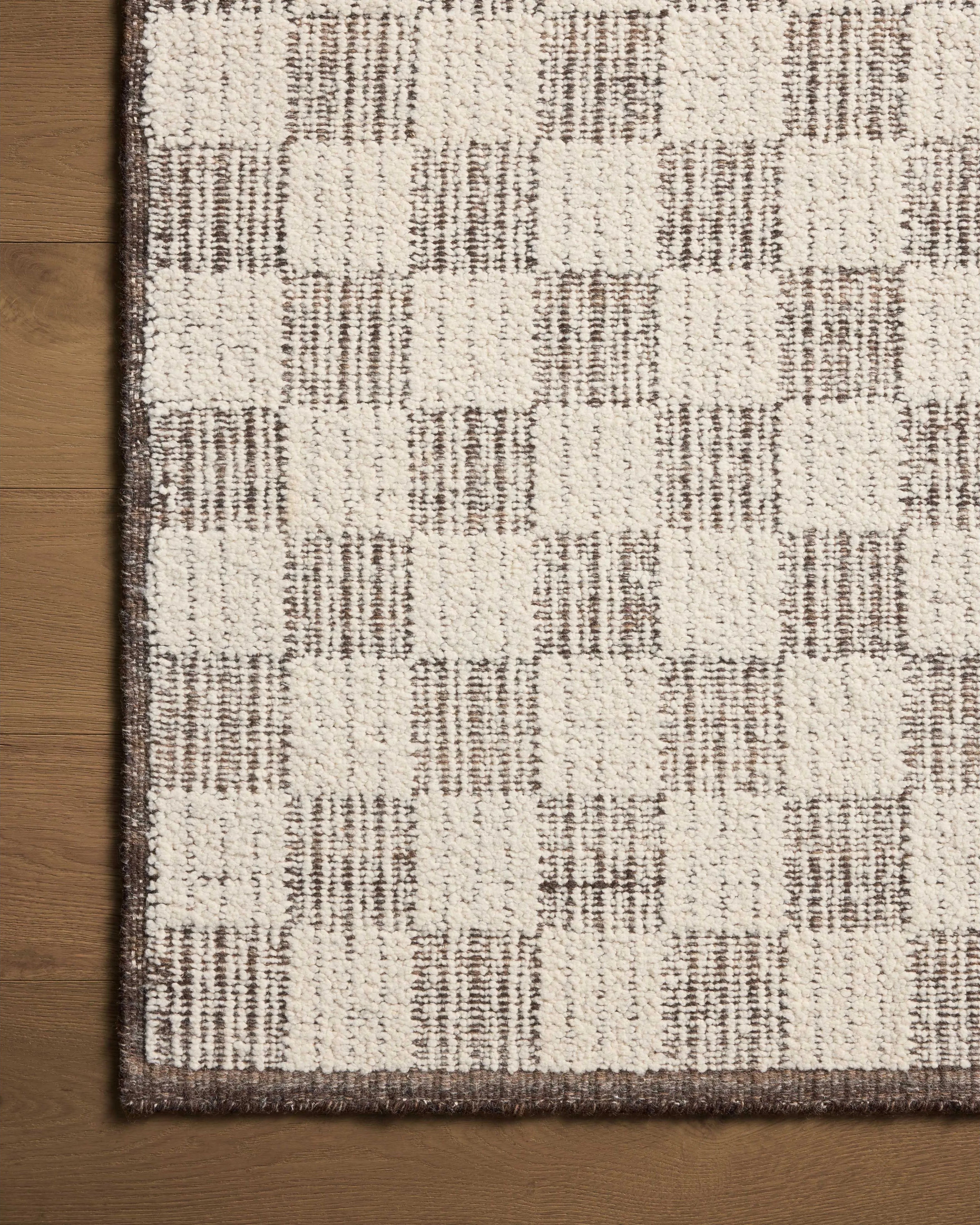 The Knox Ivory / Mocha Rug by Brigette Romanek x Loloi is a handwoven area rug with a contemporary checkerboard pattern and a texture reminiscent of a luxurious knit sweater. Made of a blend of wool and cotton that plays with scale and texture, Knox is imbued with cozy luxury that can anchor any room. Amethyst Home provides interior design, new home construction design consulting, vintage area rugs, and lighting in the Scottsdale metro area.