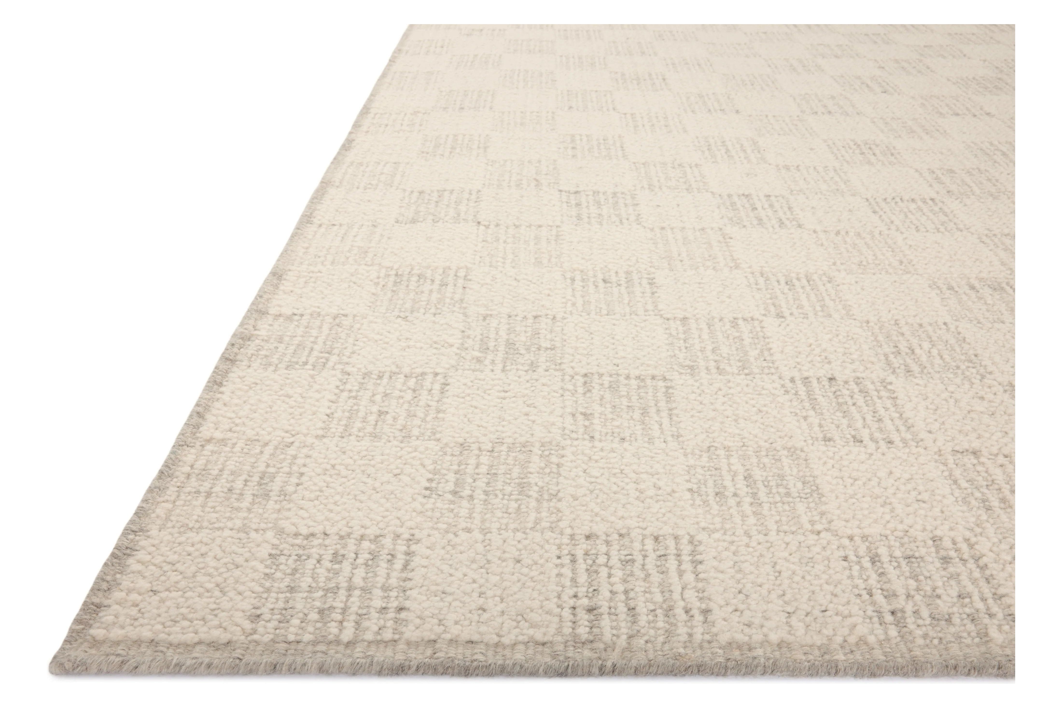 The Knox Ivory / Silver Rug by Brigette Romanek x Loloi is a handwoven area rug with a contemporary checkerboard pattern and a texture reminiscent of a luxurious knit sweater. Made of a blend of wool and cotton that plays with scale and texture, Knox is imbued with cozy luxury that can anchor any room. Amethyst Home provides interior design, new home construction design consulting, vintage area rugs, and lighting in the Portland metro area.