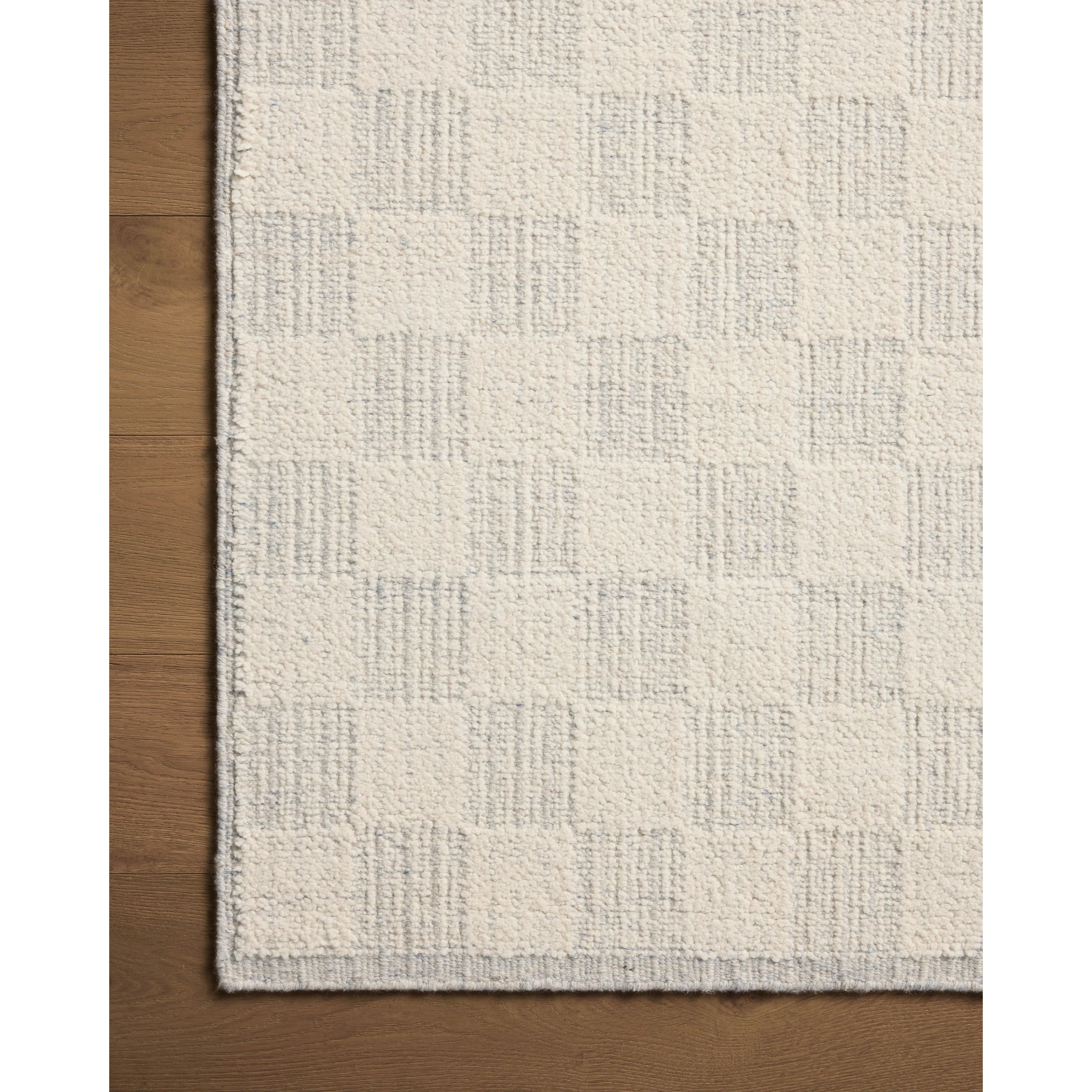 The Knox Ivory / Sky Rug by Brigette Romanek x Loloi is a handwoven area rug with a contemporary checkerboard pattern and a texture reminiscent of a luxurious knit sweater. Made of a blend of wool and cotton that plays with scale and texture, Knox is imbued with cozy luxury that can anchor any room. Amethyst Home provides interior design, new home construction design consulting, vintage area rugs, and lighting in the Austin metro area.