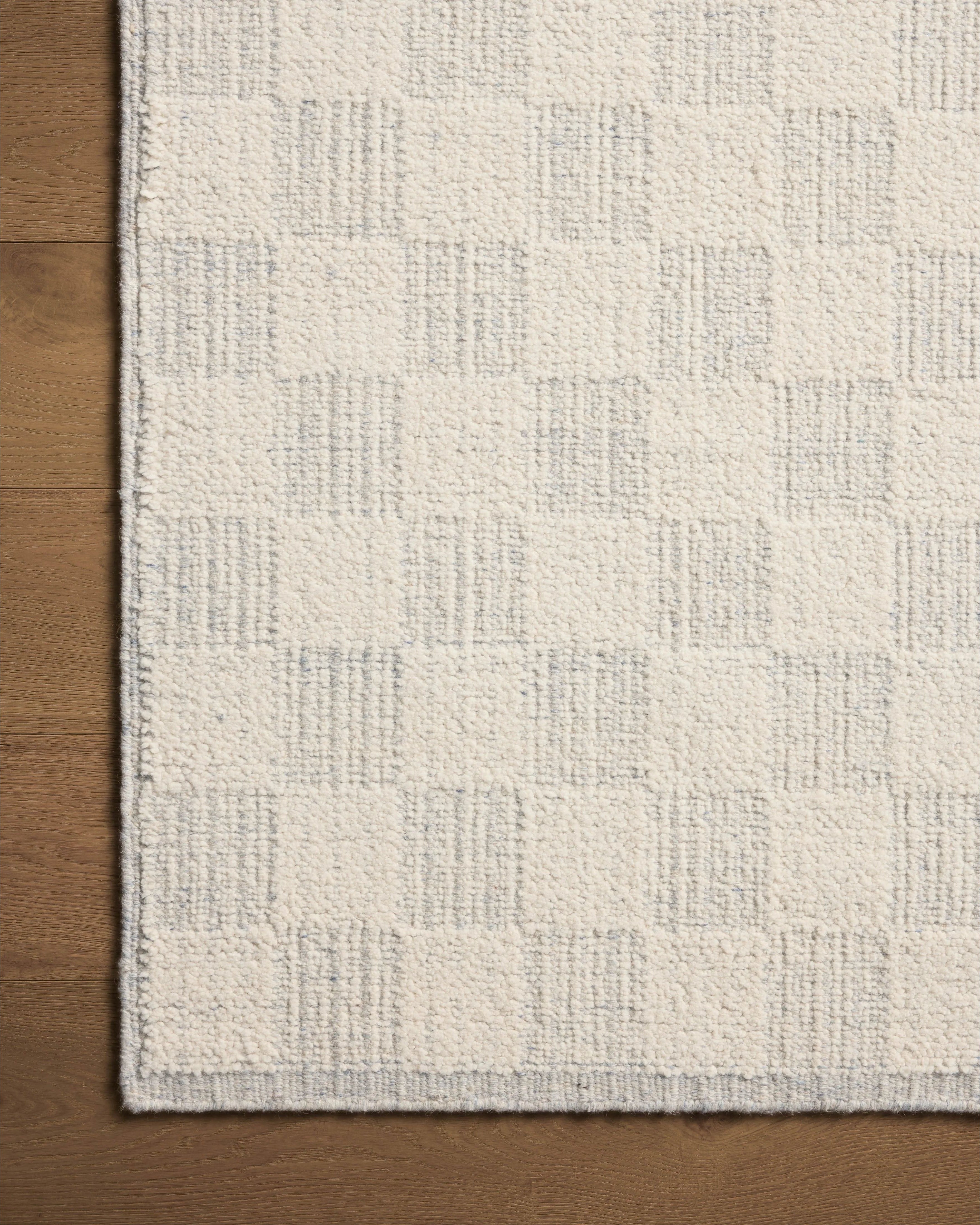 The Knox Ivory / Sky Rug by Brigette Romanek x Loloi is a handwoven area rug with a contemporary checkerboard pattern and a texture reminiscent of a luxurious knit sweater. Made of a blend of wool and cotton that plays with scale and texture, Knox is imbued with cozy luxury that can anchor any room. Amethyst Home provides interior design, new home construction design consulting, vintage area rugs, and lighting in the Austin metro area.