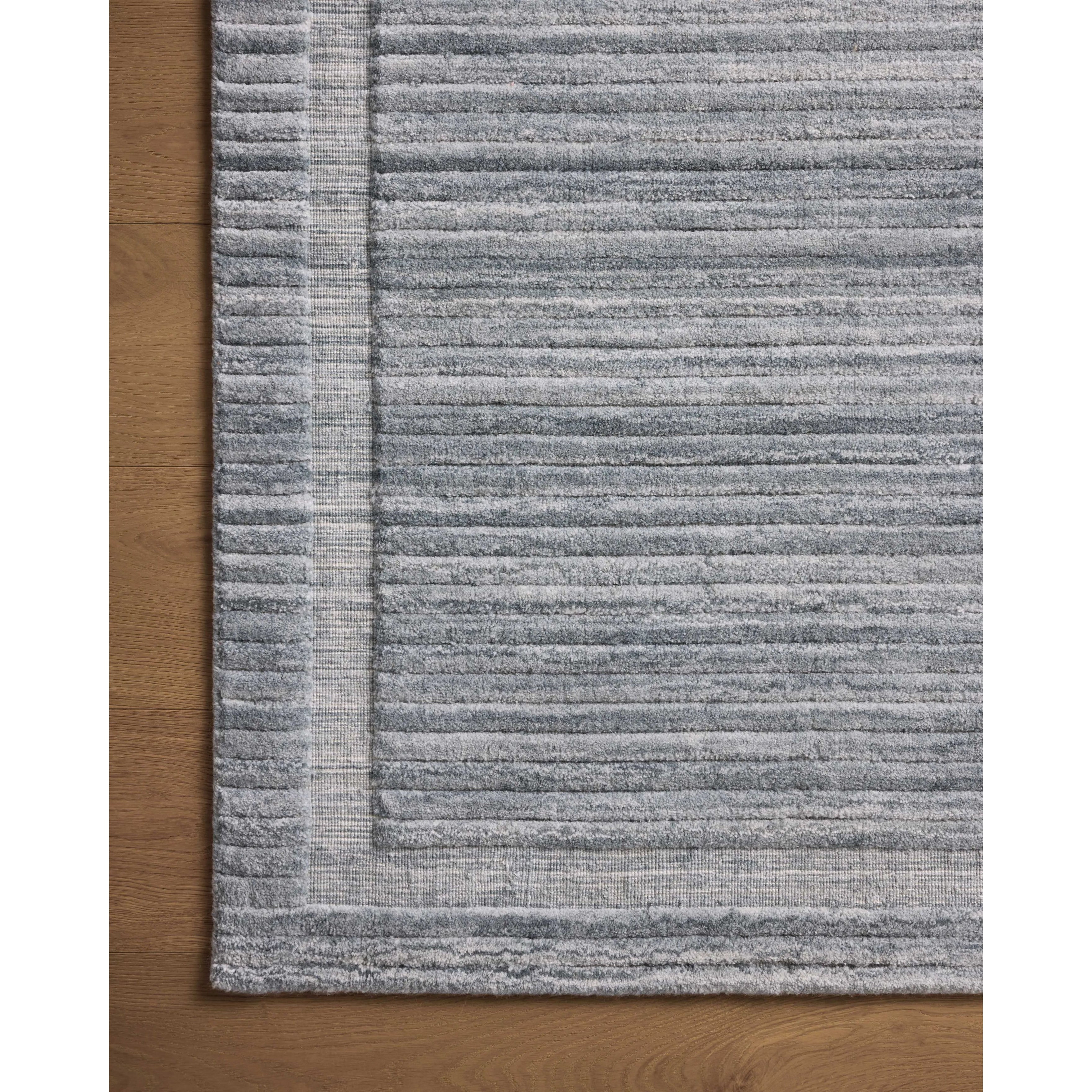 Irresistible to walk upon, the Dana Denim Rug by Brigette Romanek x Loloi has a high-low texture that alternates between a subtly shaggy pile and a soft base. Horizontal broken stripes give the area rug a fresh and energized structure, while a finish of fringe along the edges accentuates its sense of movement. Amethyst Home provides interior design, new home construction design consulting, vintage area rugs, and lighting in the Des Moines metro area.