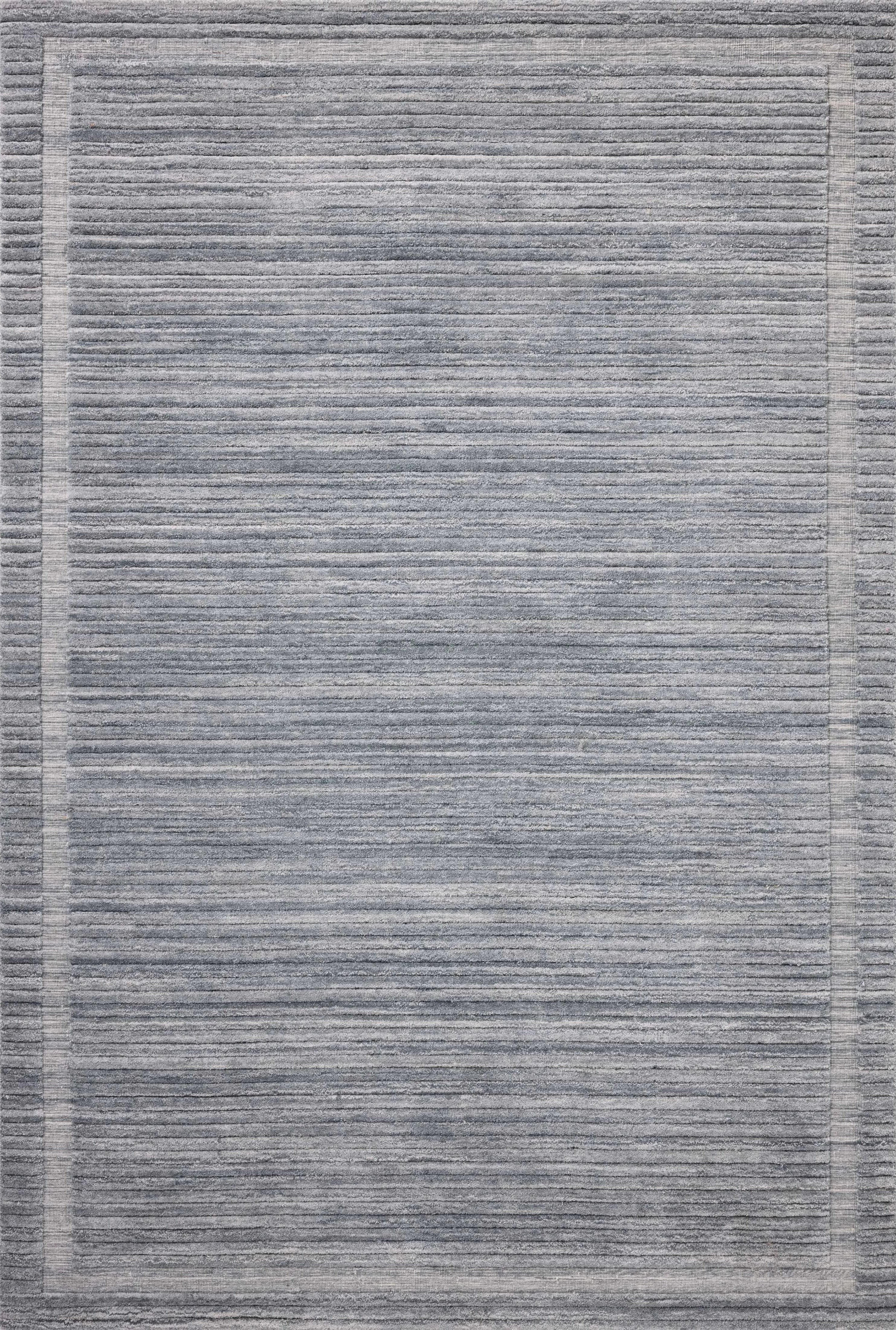 Irresistible to walk upon, the Dana Denim Rug by Brigette Romanek x Loloi has a high-low texture that alternates between a subtly shaggy pile and a soft base. Horizontal broken stripes give the area rug a fresh and energized structure, while a finish of fringe along the edges accentuates its sense of movement. Amethyst Home provides interior design, new home construction design consulting, vintage area rugs, and lighting in the Portland metro area.