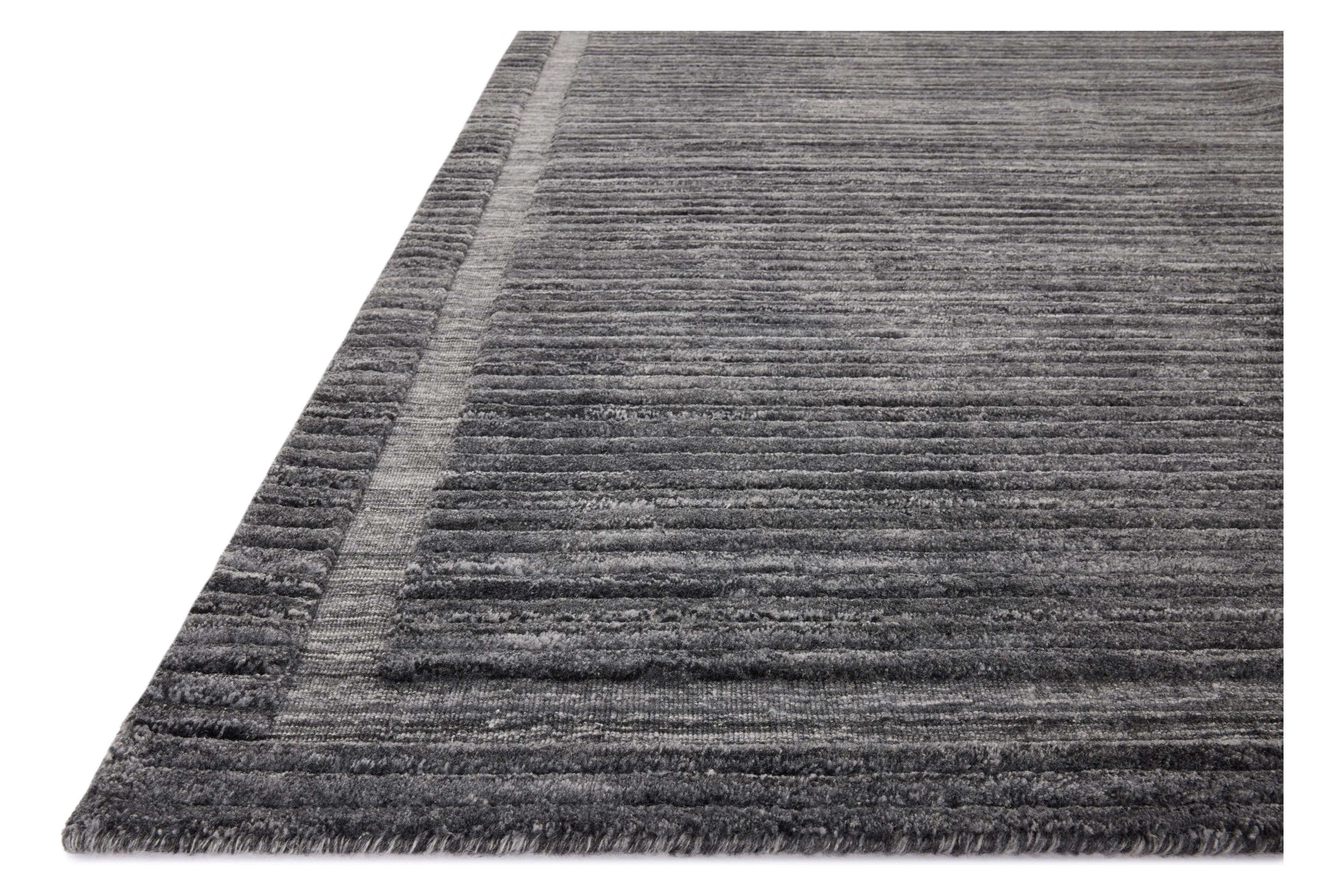 Irresistible to walk upon, the Dana Ink Rug by Brigette Romanek x Loloi has a high-low texture that alternates between a subtly shaggy pile and a soft base. Horizontal broken stripes give the area rug a fresh and energized structure, while a finish of fringe along the edges accentuates its sense of movement. Amethyst Home provides interior design, new home construction design consulting, vintage area rugs, and lighting in the Winter Garden metro area.
