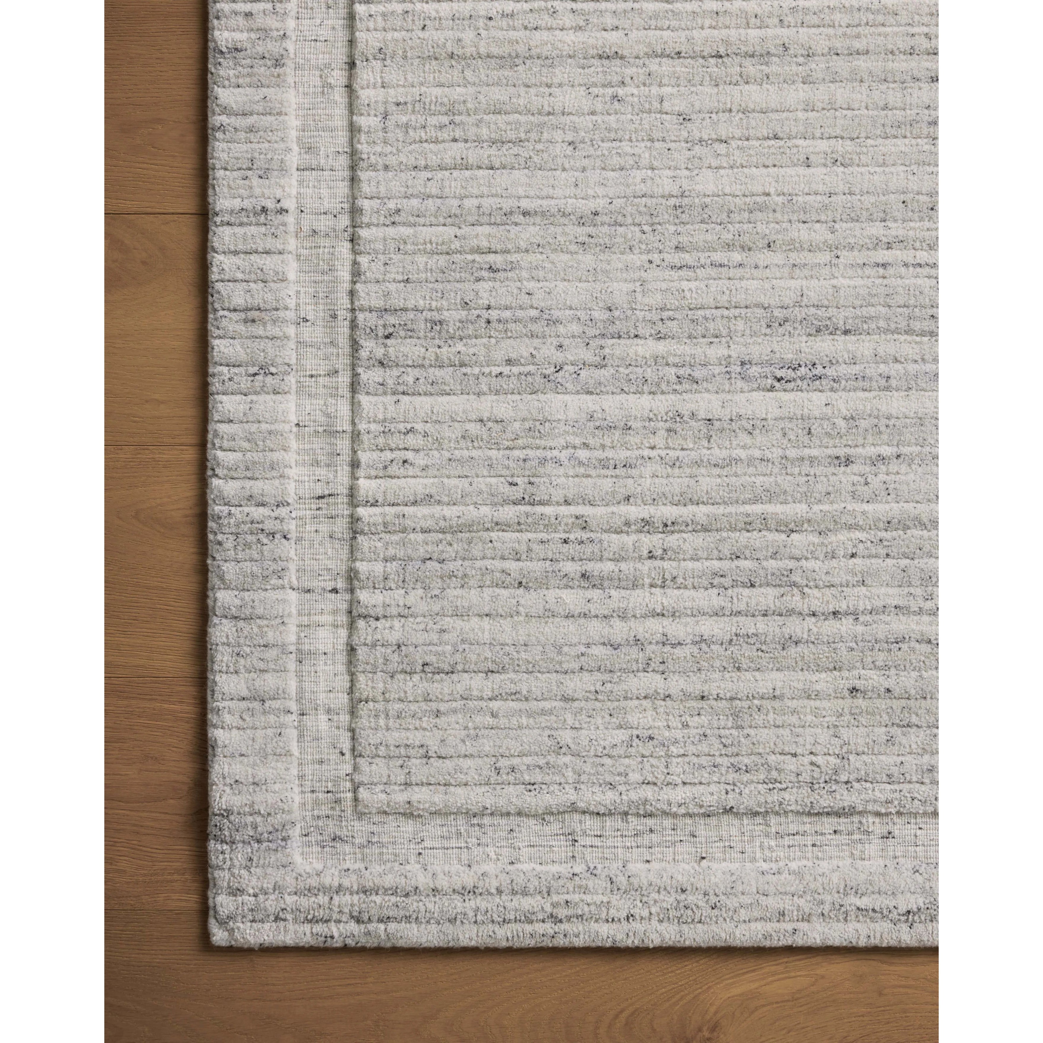 Irresistible to walk upon, the Dana Stone Rug by Brigette Romanek x Loloi has a high-low texture that alternates between a subtly shaggy pile and a soft base. Horizontal broken stripes give the area rug a fresh and energized structure, while a finish of fringe along the edges accentuates its sense of movement. Amethyst Home provides interior design, new home construction design consulting, vintage area rugs, and lighting in the Scottsdale metro area.