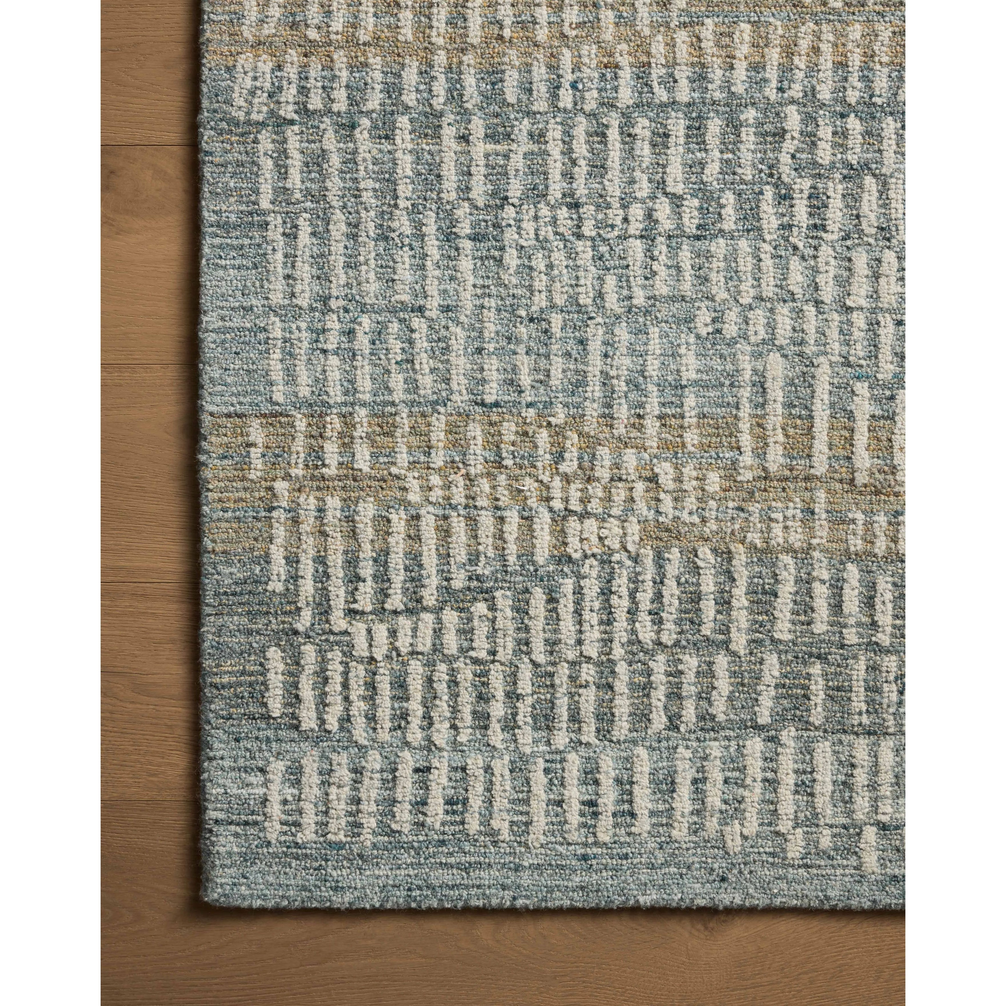 The Elias Ocean / Oatmeal Rug is a hand-tufted wool area rug with lively graphic patterns in earth and stone tones. There’s a unique texture to the rug made by over-tufting, in which a design is hand-tufted over a tufted base, creating a subtle high-low pile. Amethyst Home provides interior design, new home construction design consulting, vintage area rugs, and lighting in the Calabasas metro area.