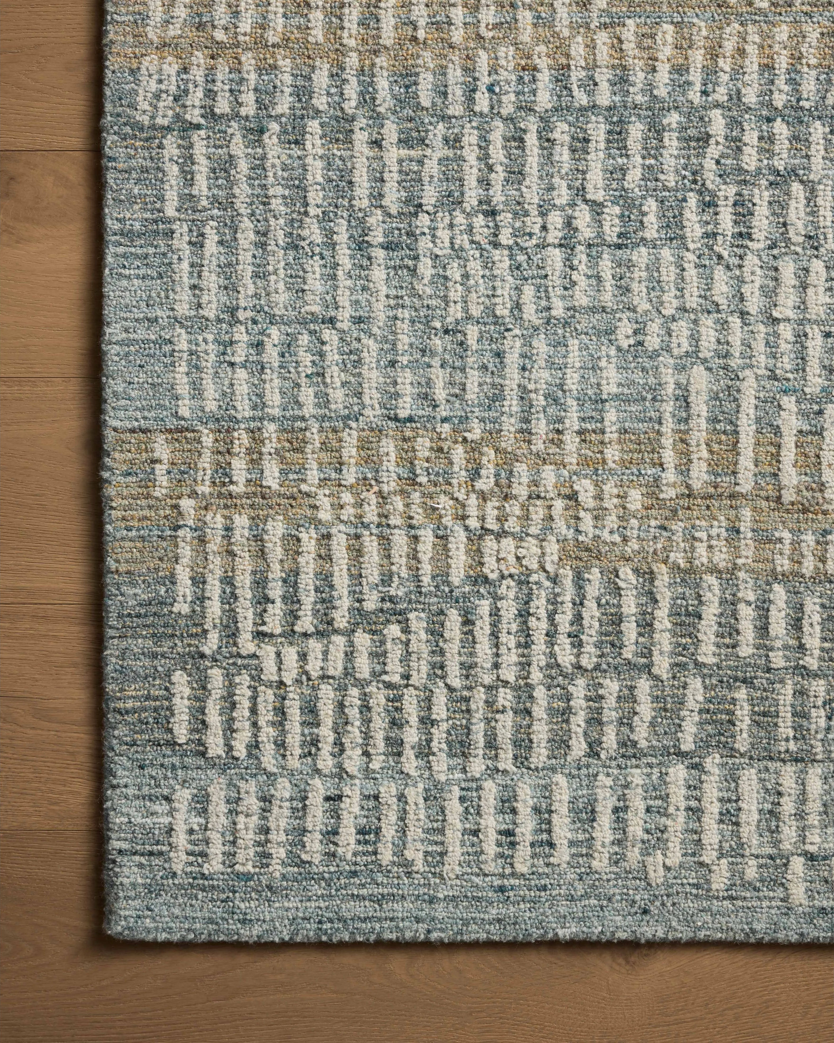 The Elias Ocean / Oatmeal Rug is a hand-tufted wool area rug with lively graphic patterns in earth and stone tones. There’s a unique texture to the rug made by over-tufting, in which a design is hand-tufted over a tufted base, creating a subtle high-low pile. Amethyst Home provides interior design, new home construction design consulting, vintage area rugs, and lighting in the Calabasas metro area.