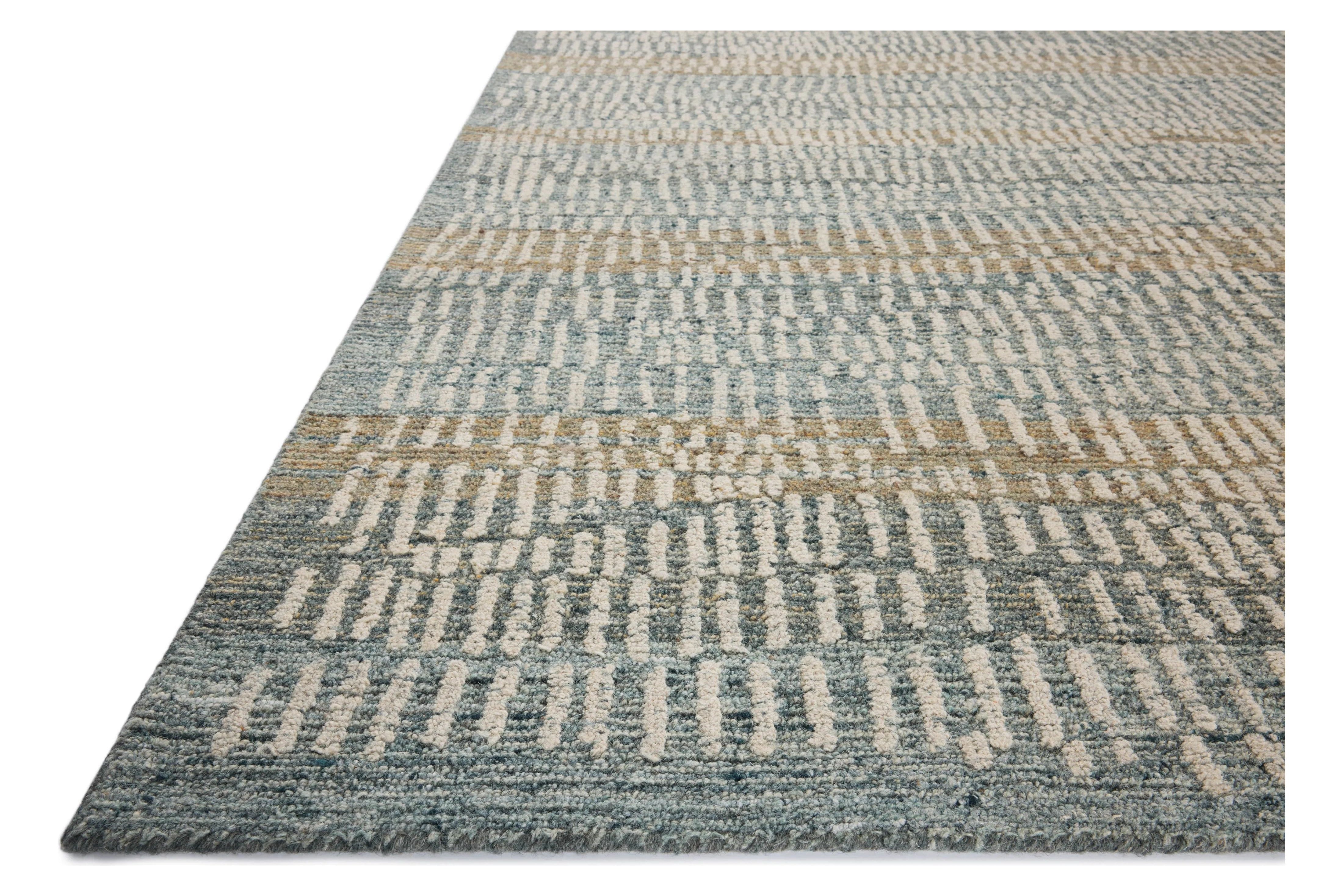 The Elias Ocean / Oatmeal Rug is a hand-tufted wool area rug with lively graphic patterns in earth and stone tones. There’s a unique texture to the rug made by over-tufting, in which a design is hand-tufted over a tufted base, creating a subtle high-low pile. Amethyst Home provides interior design, new home construction design consulting, vintage area rugs, and lighting in the Laguna Beach metro area.