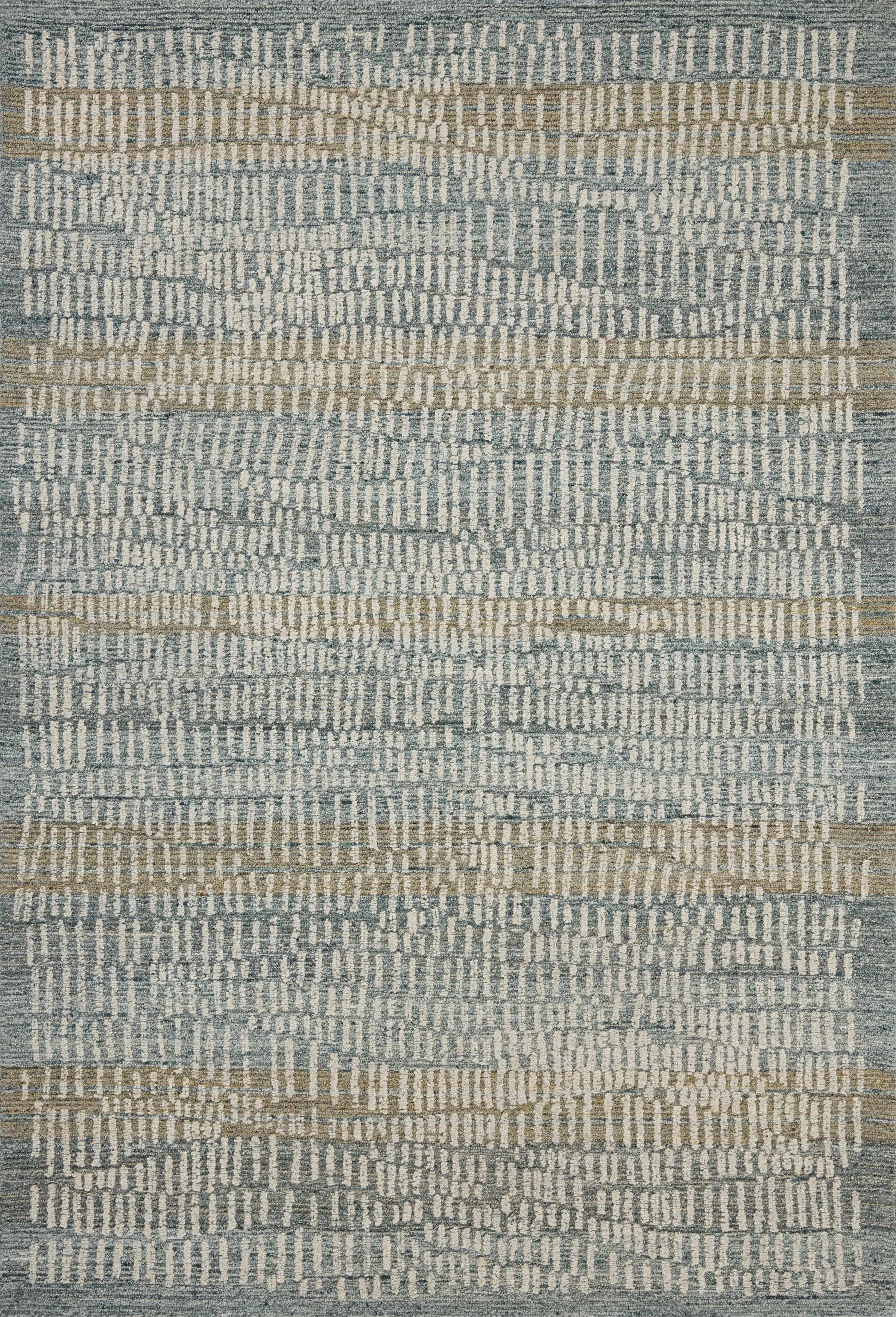 The Elias Ocean / Oatmeal Rug is a hand-tufted wool area rug with lively graphic patterns in earth and stone tones. There’s a unique texture to the rug made by over-tufting, in which a design is hand-tufted over a tufted base, creating a subtle high-low pile. Amethyst Home provides interior design, new home construction design consulting, vintage area rugs, and lighting in the Miami metro area.