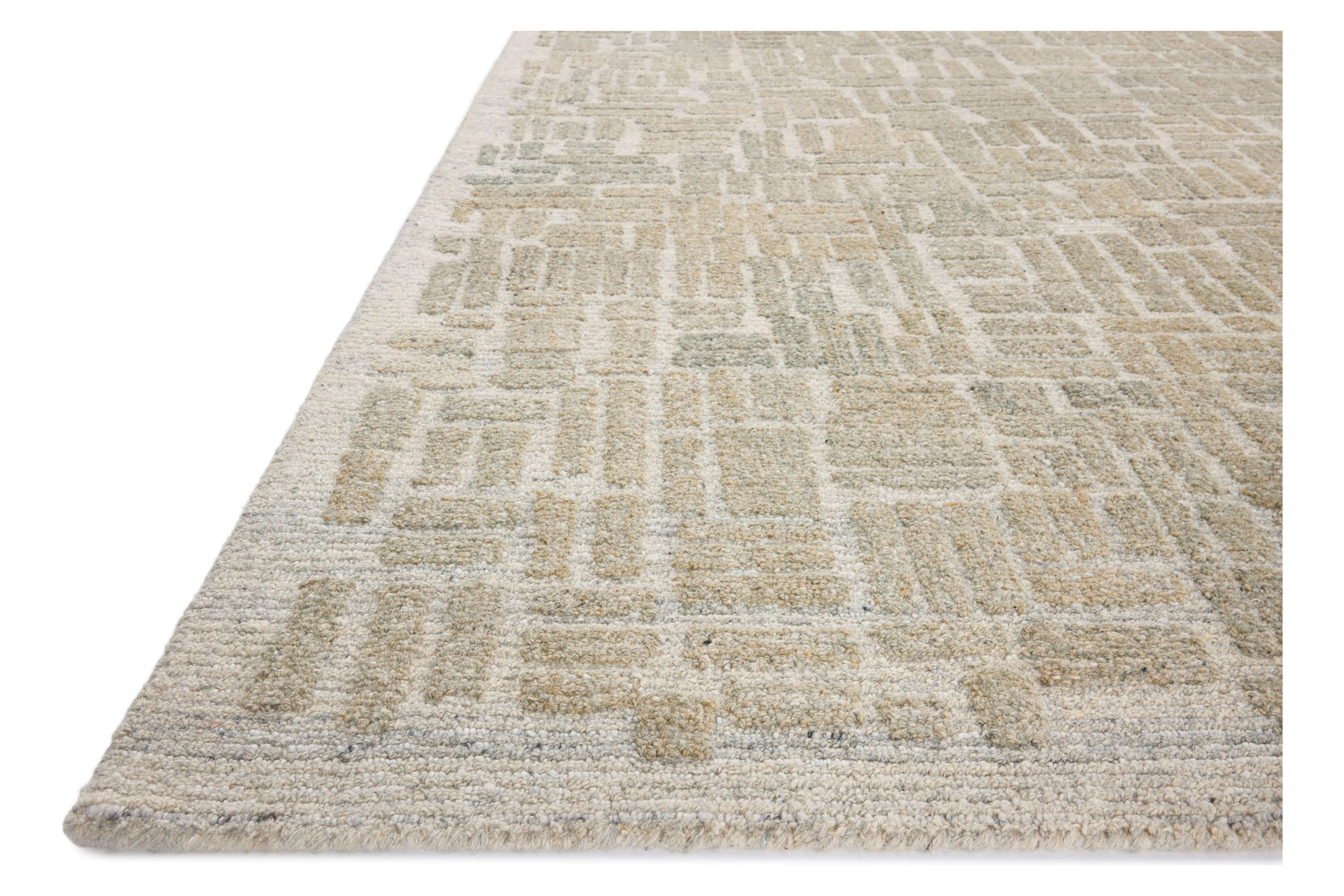 The Elias Pebble / Sage Rug is a hand-tufted wool area rug with lively graphic patterns in earth and stone tones. There’s a unique texture to the rug made by over-tufting, in which a design is hand-tufted over a tufted base, creating a subtle high-low pile. Amethyst Home provides interior design, new home construction design consulting, vintage area rugs, and lighting in the Park City metro area.