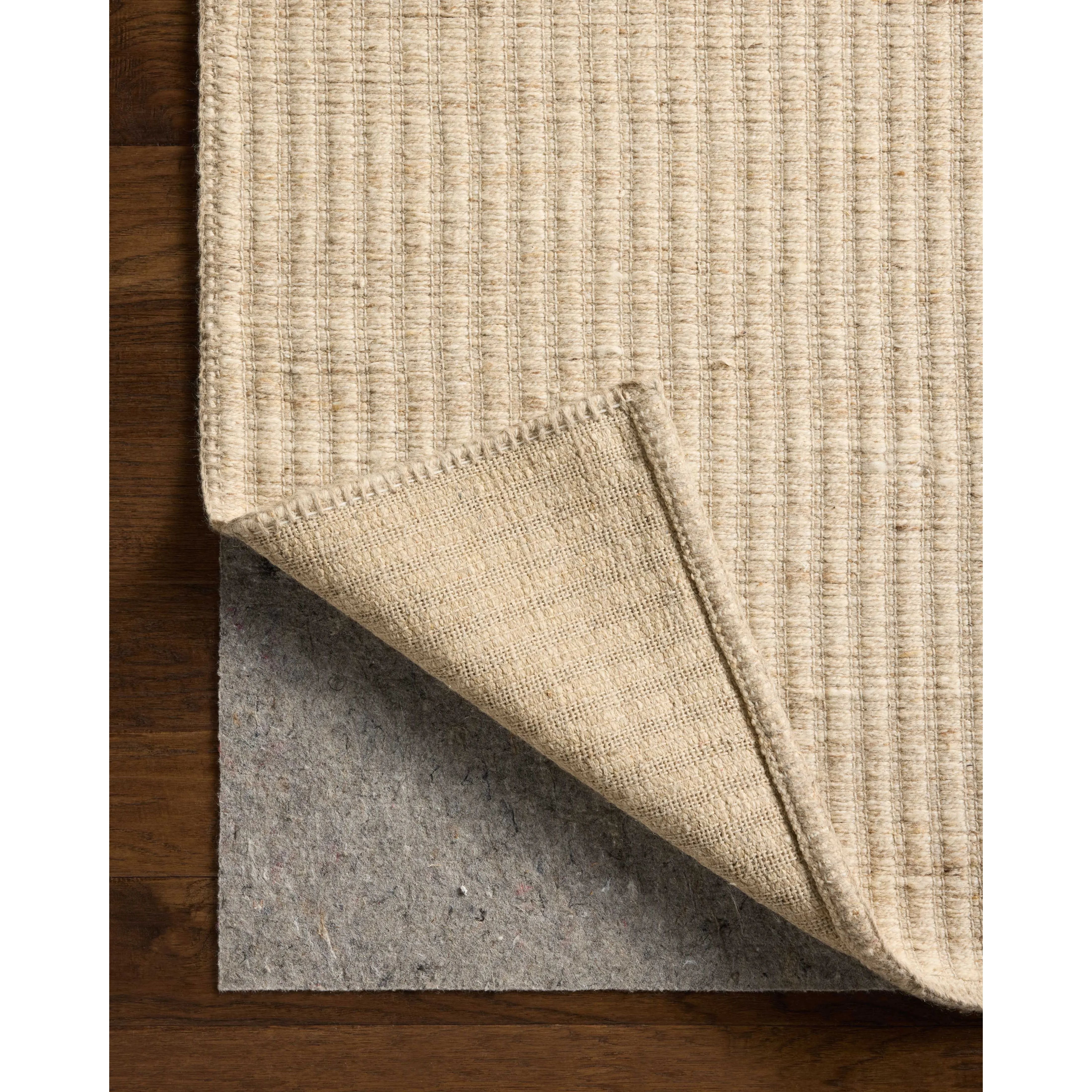 The Elma Collection is a vertically striped area rug framed with whip-stitched edges to help ground your space. This timeless, neutral rug is great for high-traffic living rooms, bedrooms, and dining rooms of many home decor styles. Amethyst Home provides interior design, new home construction design consulting, vintage area rugs, and lighting in the Tampa metro area.