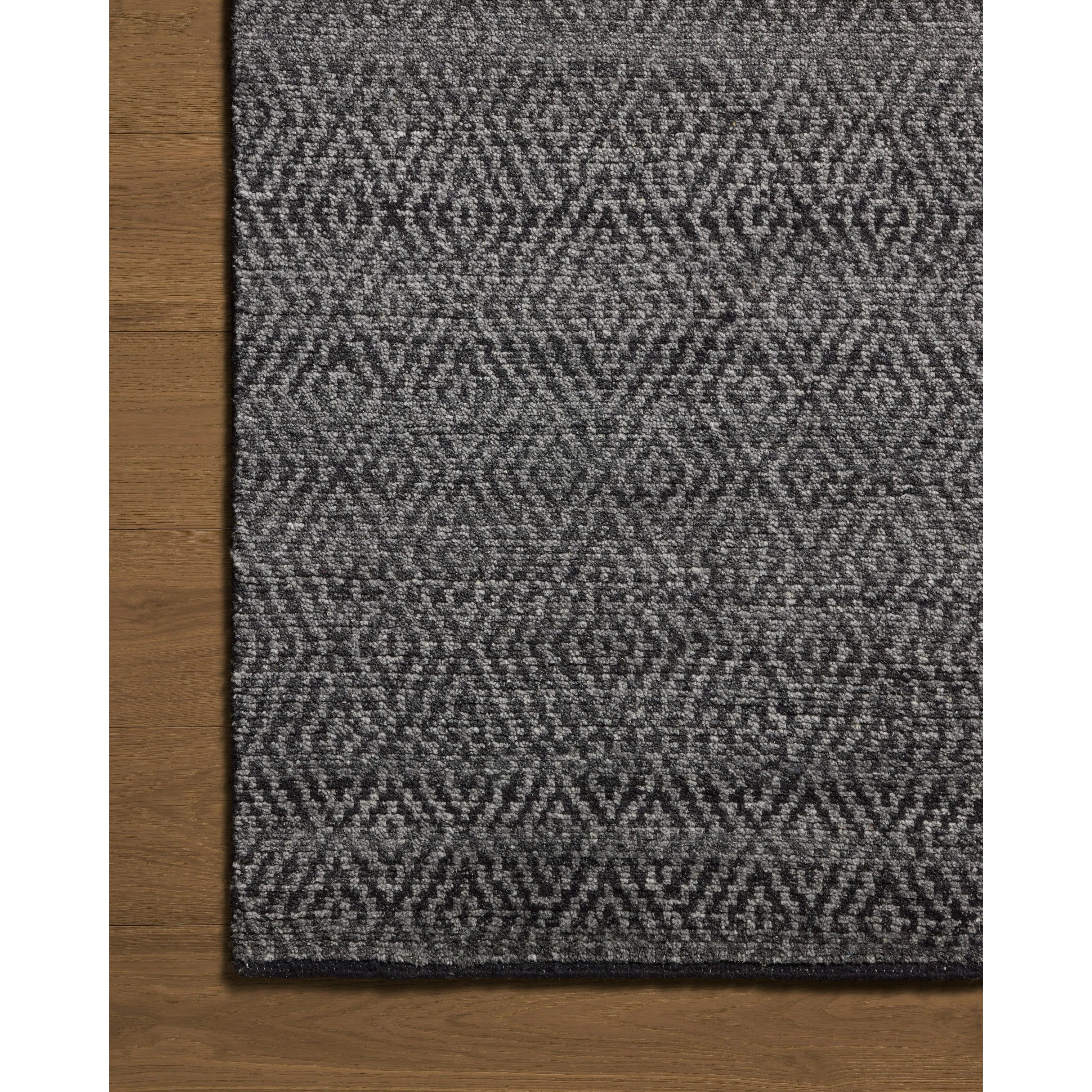 The Grace Charcoal Rug is a hand-knotted area rug with patterns inspired by traditional suiting fabrics, like houndstooth and tweed. The design’s smaller-scale patterns create depth, while the classic patterns invoke the warmth of English countryside interiors. Amethyst Home provides interior design, new home construction design consulting, vintage area rugs, and lighting in the Alpharetta metro area.
