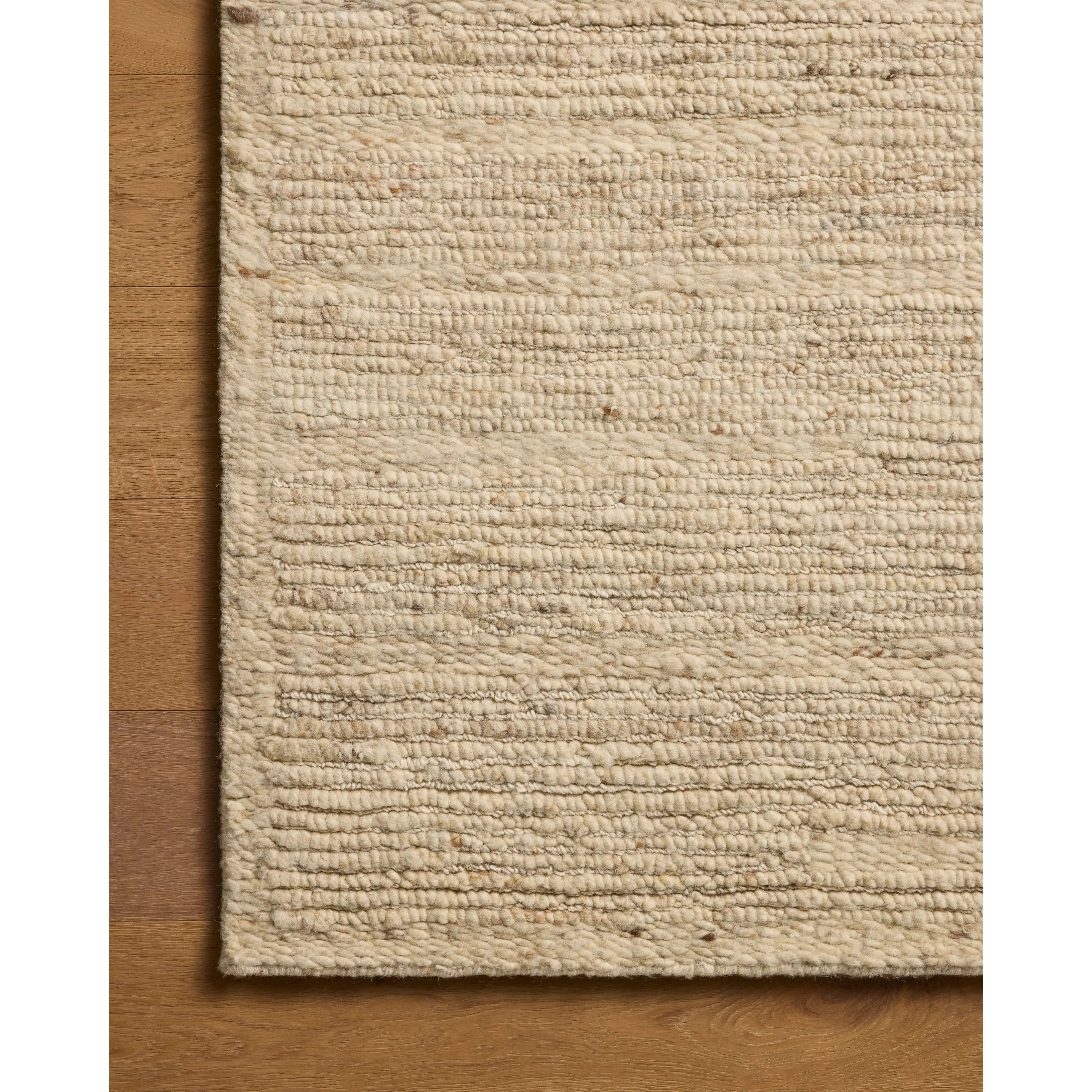 The Lennox Collection by Leanne Ford x Loloi is a statement area rug made with natural undyed wool that reveals subtle color differentiation in creamy neutral tones. The rug is hand-woven with a labor-intensive soumak weave, alternating rows of thick and thin looped yarns for an organic, inviting texture. Amethyst Home provides interior design, new home construction design consulting, vintage area rugs, and lighting in the Tampa metro area.