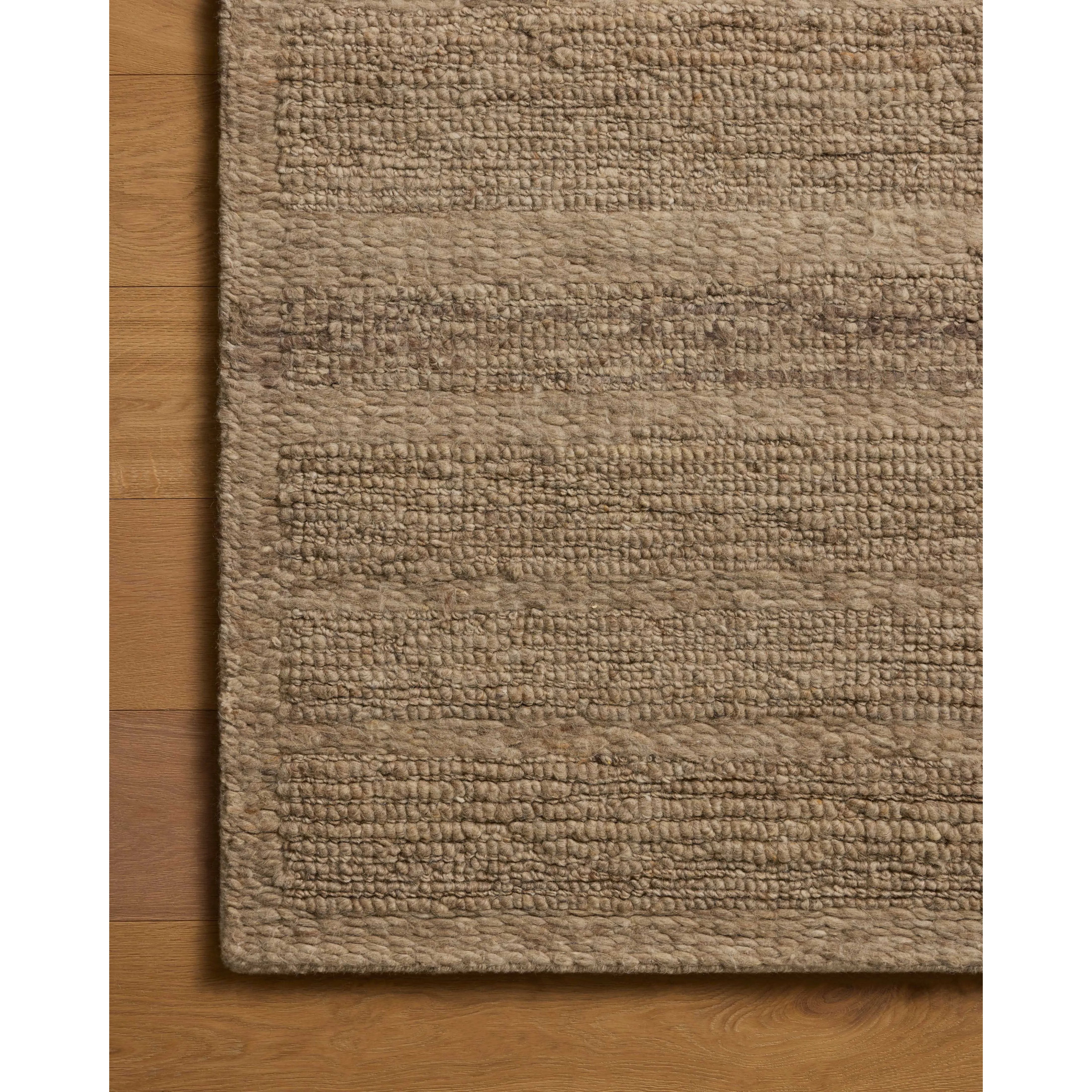 The Lennox Collection by Leanne Ford x Loloi is a statement area rug made with natural undyed wool that reveals subtle color differentiation in creamy neutral tones. The rug is hand-woven with a labor-intensive soumak weave, alternating rows of thick and thin looped yarns for an organic, inviting texture. Amethyst Home provides interior design, new home construction design consulting, vintage area rugs, and lighting in the Newport Beach metro area.