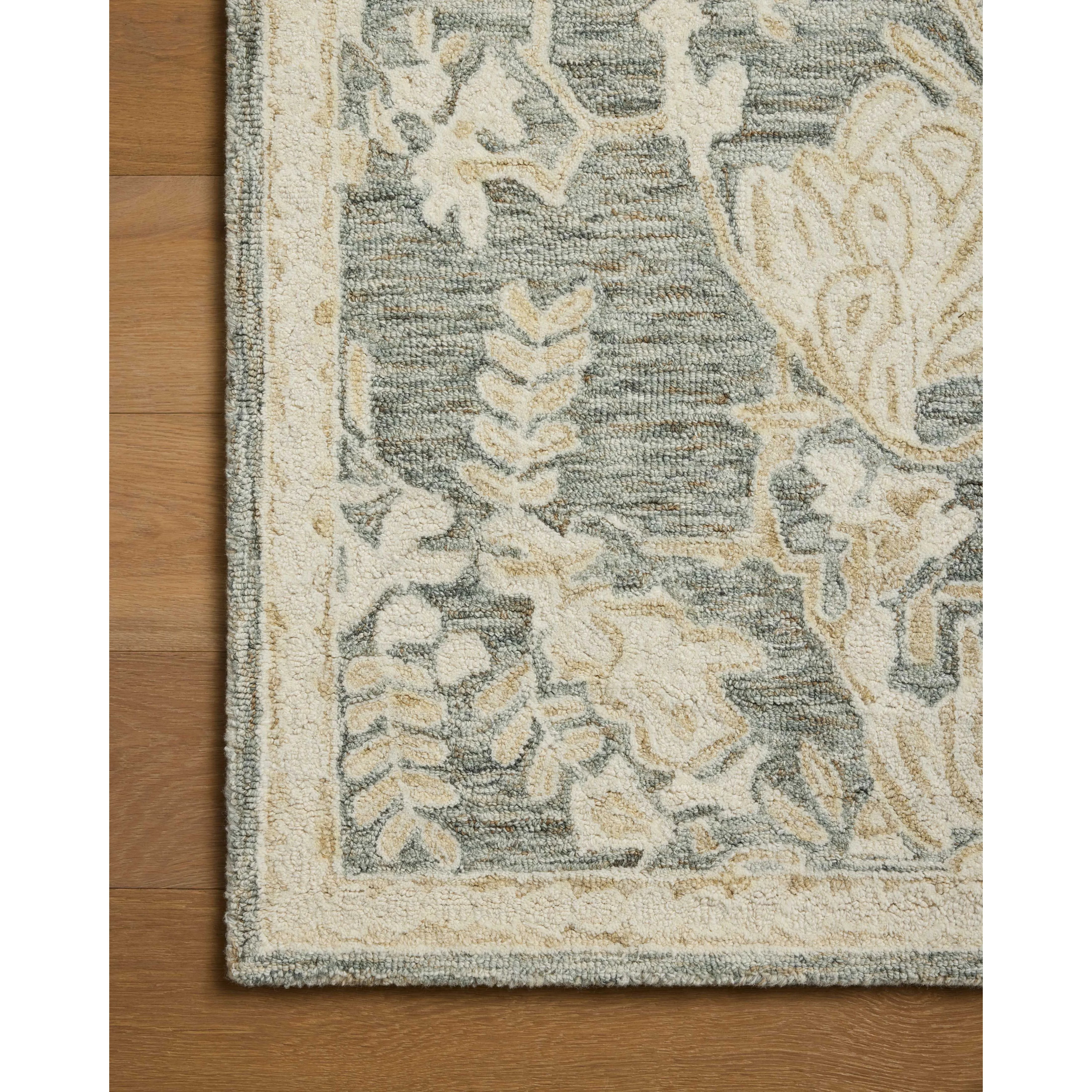 The Lenore Collection is a floral wool area rug with a two-toned design for elegant home decor. The rug's intricate linework is cut pile and the base is looped yarn, which gives the florals a slightly raised appearance and lovely depth. Amethyst Home provides interior design, new home construction design consulting, vintage area rugs, and lighting in the Salt Lake City metro area.