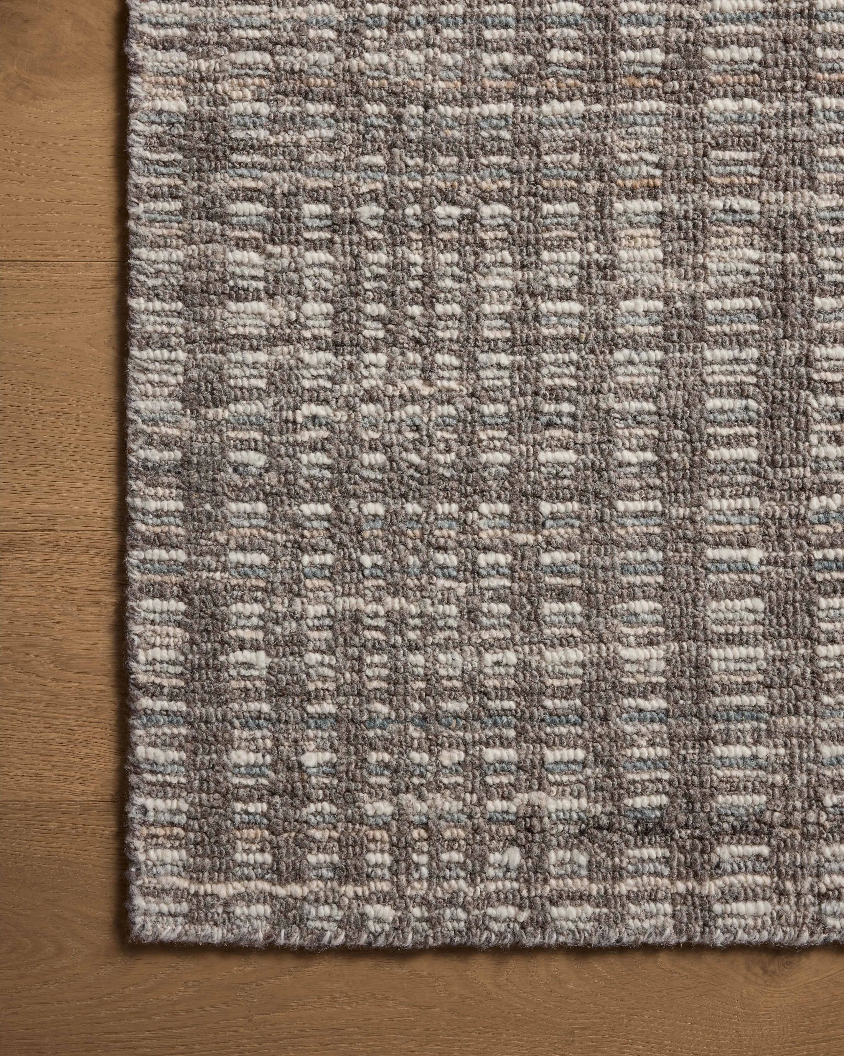 The Sonya Granite / Multi Rug is a hand-loomed area rug with a light, airy palette and understated graphic design. The rug’s textural pile is a soft blend of wool and nylon that creates dimension in living rooms, bedrooms, and more. Amethyst Home provides interior design, new home construction design consulting, vintage area rugs, and lighting in the Tampa metro area.