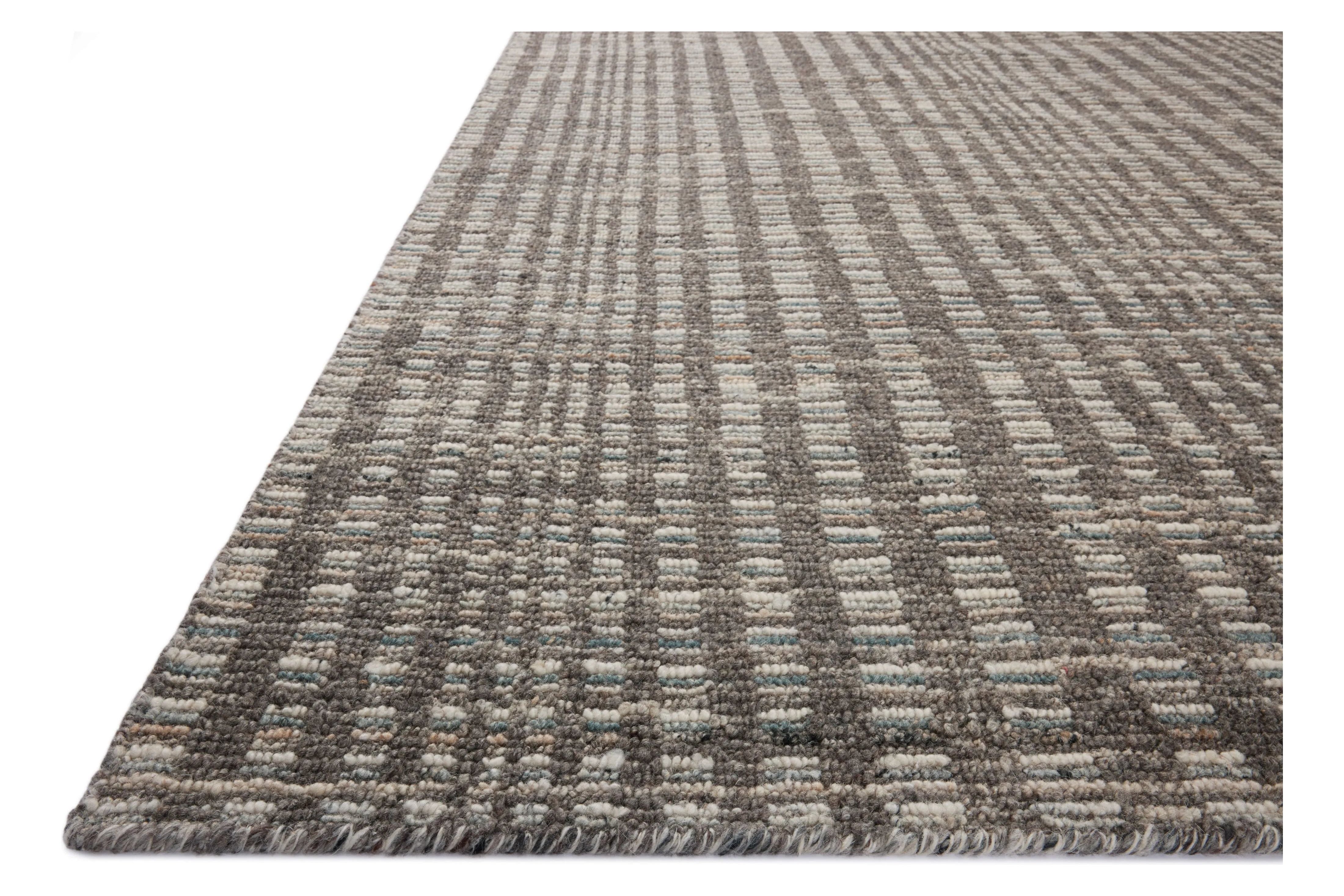 The Sonya Granite / Multi Rug is a hand-loomed area rug with a light, airy palette and understated graphic design. The rug’s textural pile is a soft blend of wool and nylon that creates dimension in living rooms, bedrooms, and more. Amethyst Home provides interior design, new home construction design consulting, vintage area rugs, and lighting in the Winter Garden metro area.