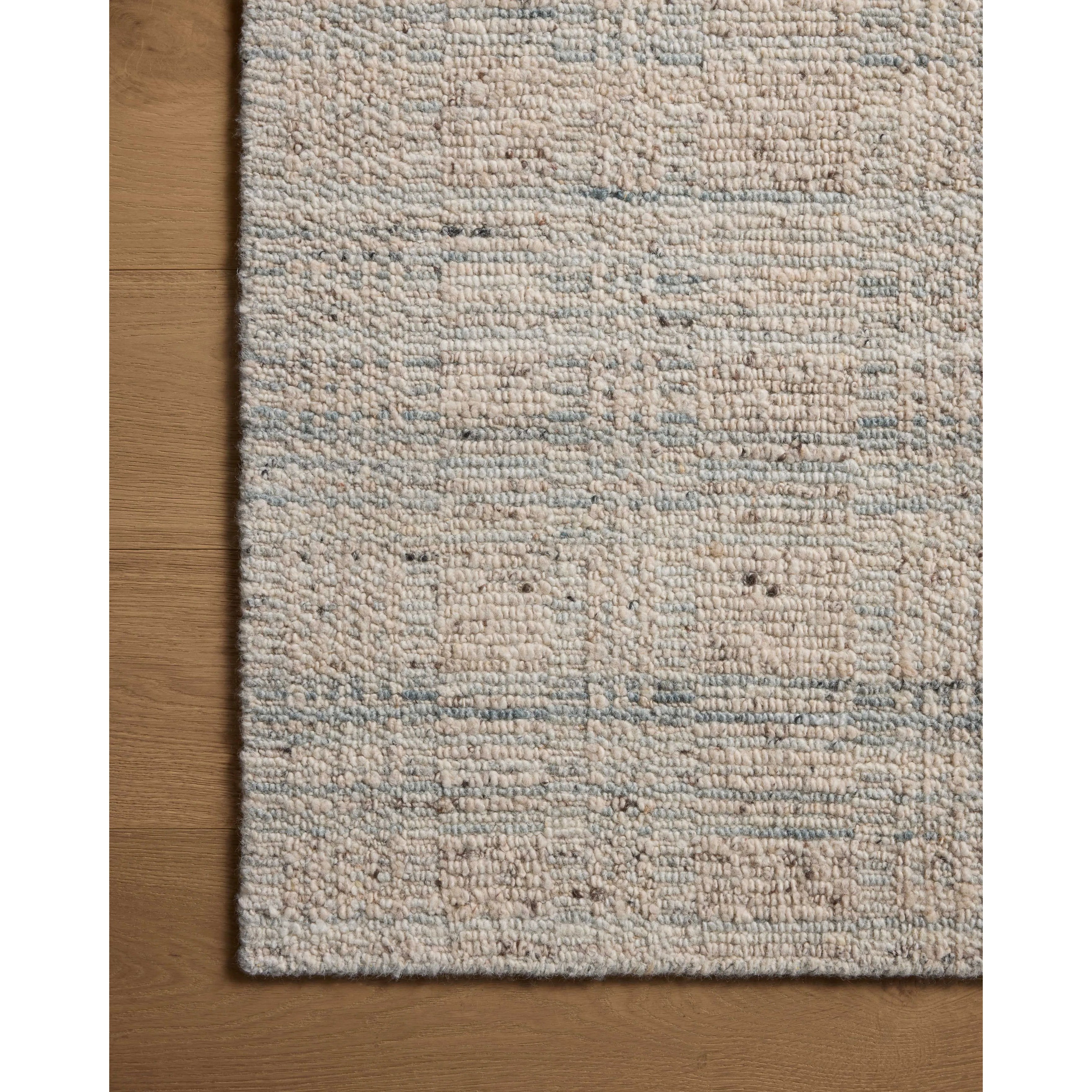 The Sonya Mist / Oatmeal Rug is a hand-loomed area rug with a light, airy palette and understated graphic design. The rug’s textural pile is a soft blend of wool and nylon that creates dimension in living rooms, bedrooms, and more. Amethyst Home provides interior design, new home construction design consulting, vintage area rugs, and lighting in the Charlotte metro area.