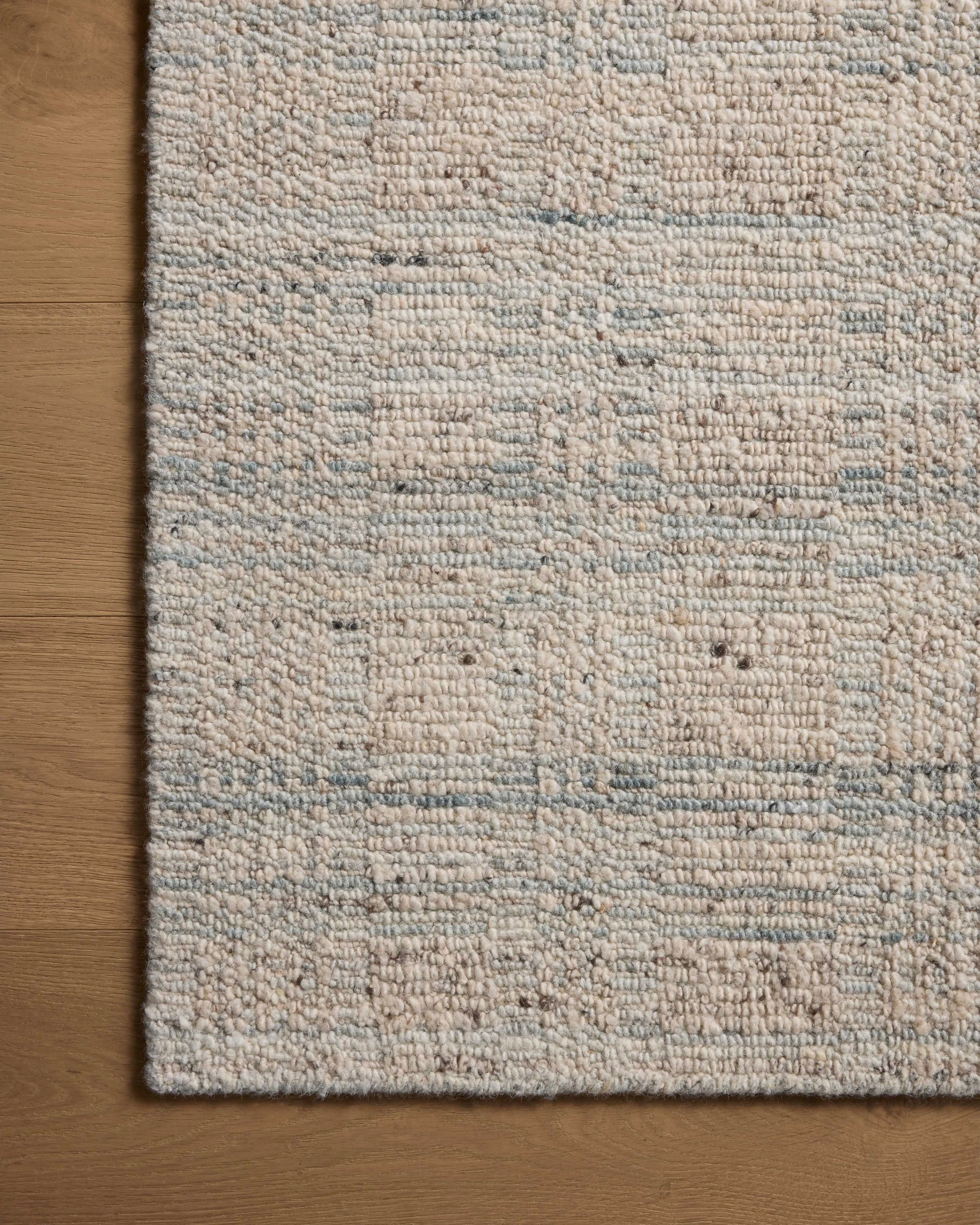 The Sonya Mist / Oatmeal Rug is a hand-loomed area rug with a light, airy palette and understated graphic design. The rug’s textural pile is a soft blend of wool and nylon that creates dimension in living rooms, bedrooms, and more. Amethyst Home provides interior design, new home construction design consulting, vintage area rugs, and lighting in the Charlotte metro area.