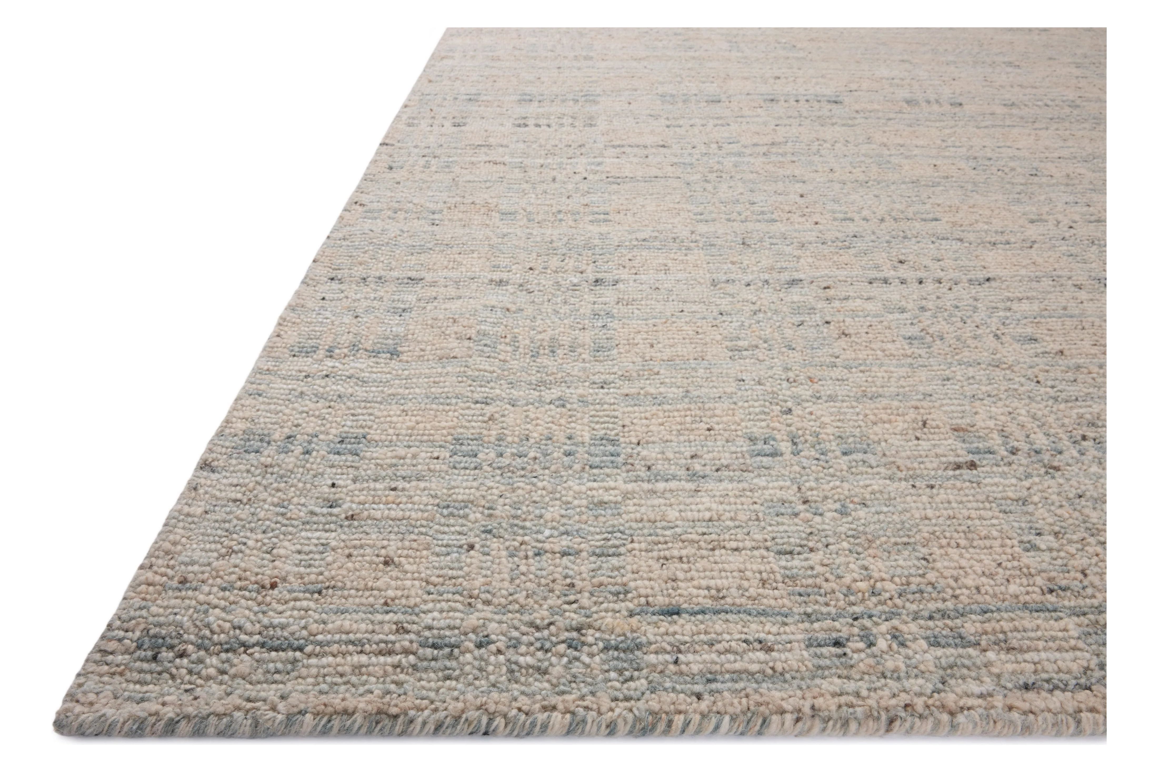 The Sonya Mist / Oatmeal Rug is a hand-loomed area rug with a light, airy palette and understated graphic design. The rug’s textural pile is a soft blend of wool and nylon that creates dimension in living rooms, bedrooms, and more. Amethyst Home provides interior design, new home construction design consulting, vintage area rugs, and lighting in the Laguna Beach metro area.