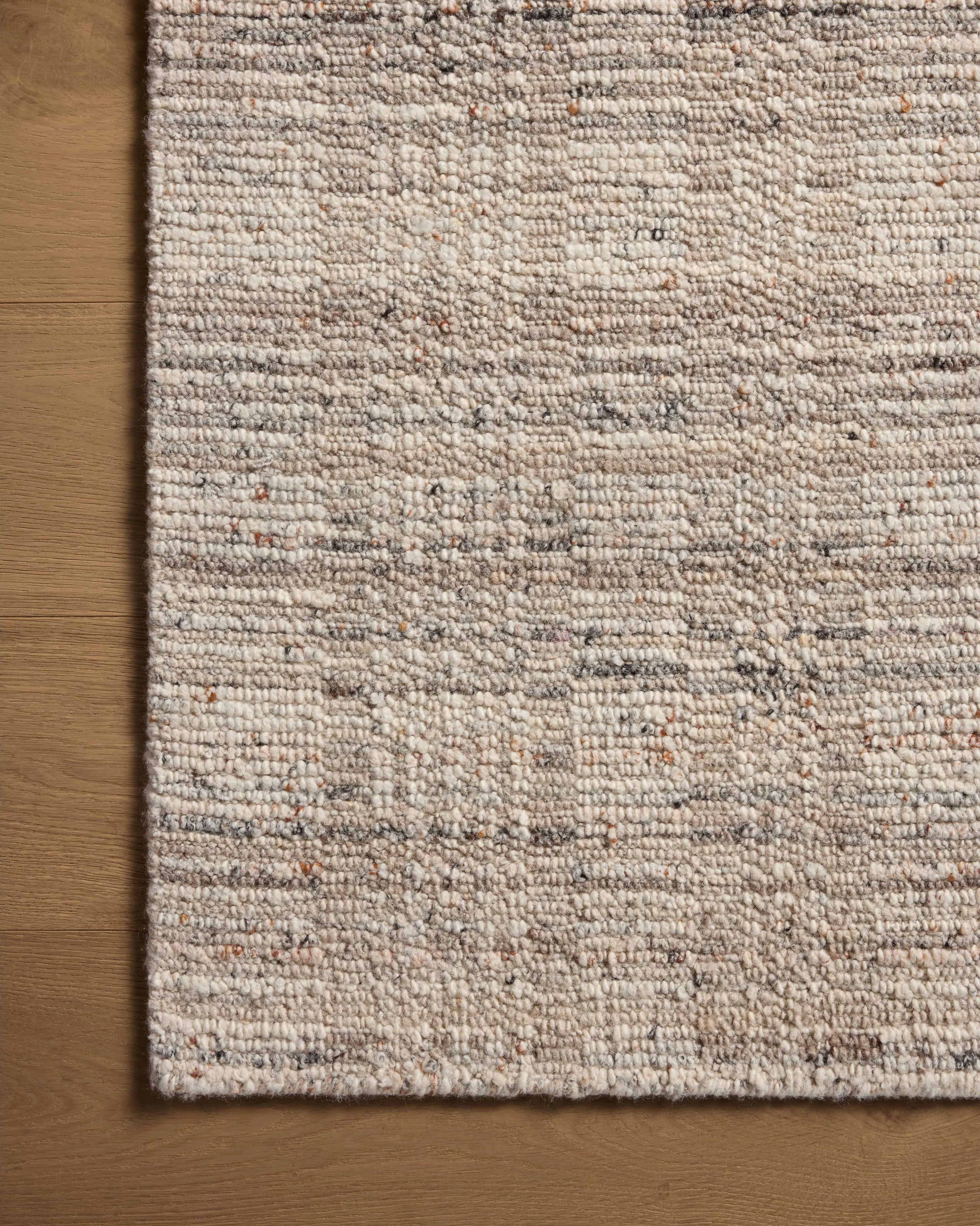 The Sonya Pebble / Fog Rug is a hand-loomed area rug with a light, airy palette and understated graphic design. The rug’s textural pile is a soft blend of wool and nylon that creates dimension in living rooms, bedrooms, and more. Amethyst Home provides interior design, new home construction design consulting, vintage area rugs, and lighting in the Newport Beach metro area.