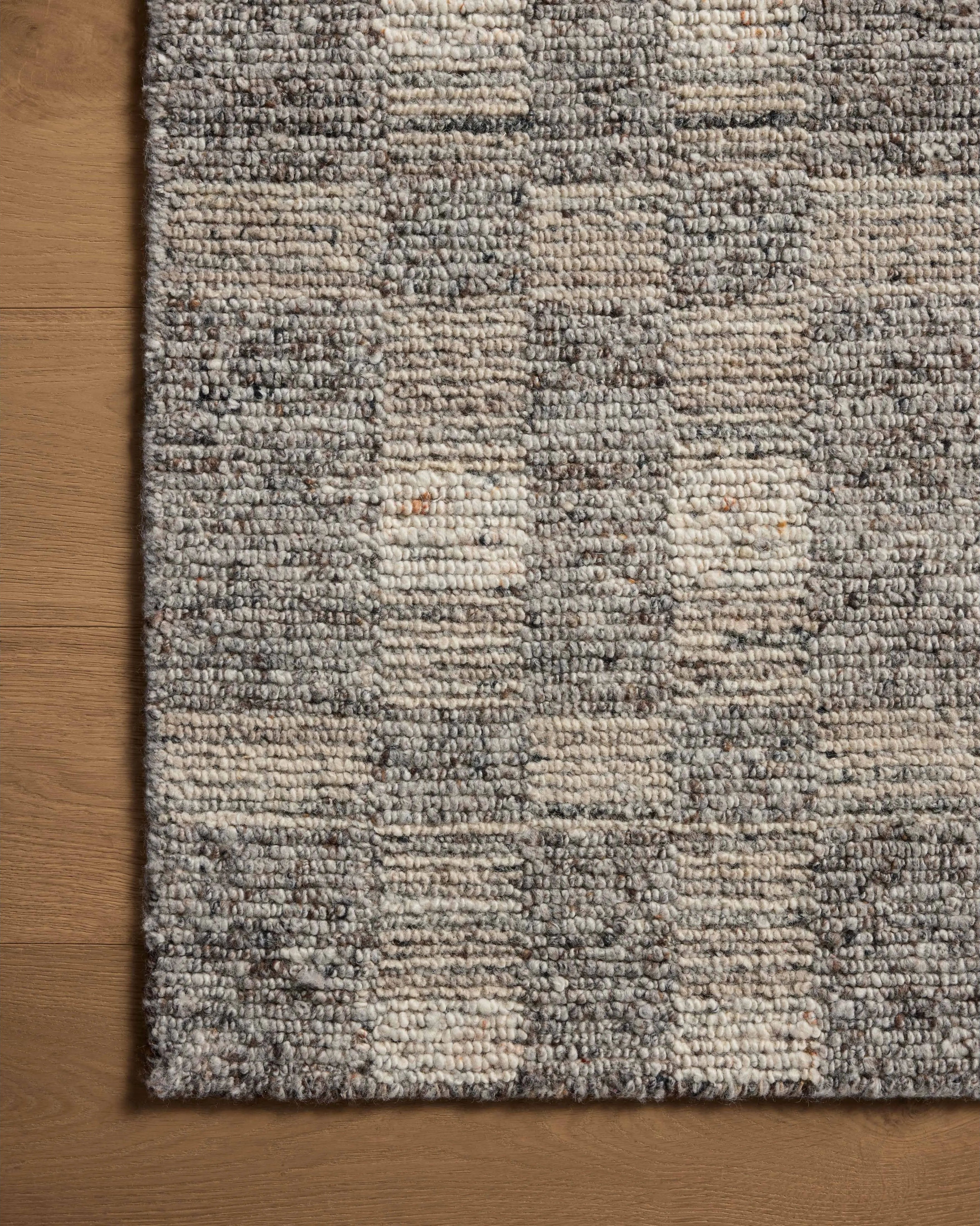 The Sonya Stone / Natural Rug is a hand-loomed area rug with a light, airy palette and understated graphic design. The rug’s textural pile is a soft blend of wool and nylon that creates dimension in living rooms, bedrooms, and more. Amethyst Home provides interior design, new home construction design consulting, vintage area rugs, and lighting in the Tampa metro area.
