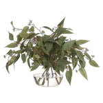 Create a luxurious atmosphere with this green Eucalyptus, housed in a glass vase. Reaching 19", it's a graceful addition that enhances small nooks, shelves, or bathroom vanities, adding a refined touch. Experience the charm of this arrangement, maintenance-free and ideal for those who love fresh, vibrant decor Amethyst Home provides interior design, new home construction design consulting, vintage area rugs, and lighting in the Monterey metro area.