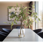 Bring timeless beauty into your home with the green Eucalyptus in a glass jug. With a height of 35", this arrangement offers a striking and elegant presence, blending seamlessly with seasonal or year-round decor. Enjoy its lasting beauty year-round, perfect for adding seasonal flair without any upkeep Amethyst Home provides interior design, new home construction design consulting, vintage area rugs, and lighting in the Tampa metro area.