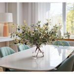 Embrace nature's charm with the green Olive Branch, thoughtfully displayed in a glass vase. With a height of 25", this arrangement offers a striking and elegant presence, blending seamlessly with seasonal or year-round decor. Enjoy its lasting beauty year-round, perfect for adding seasonal flair without any upkeep Amethyst Home provides interior design, new home construction design consulting, vintage area rugs, and lighting in the Tampa metro area.