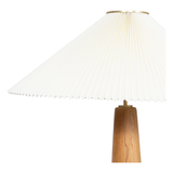 Modern minimal meets traditional. A tapered wood floor lamp base is topped with a design-forward pleated shade. Amethyst Home provides interior design, new home construction design consulting, vintage area rugs, and lighting in the Dallas metro area.