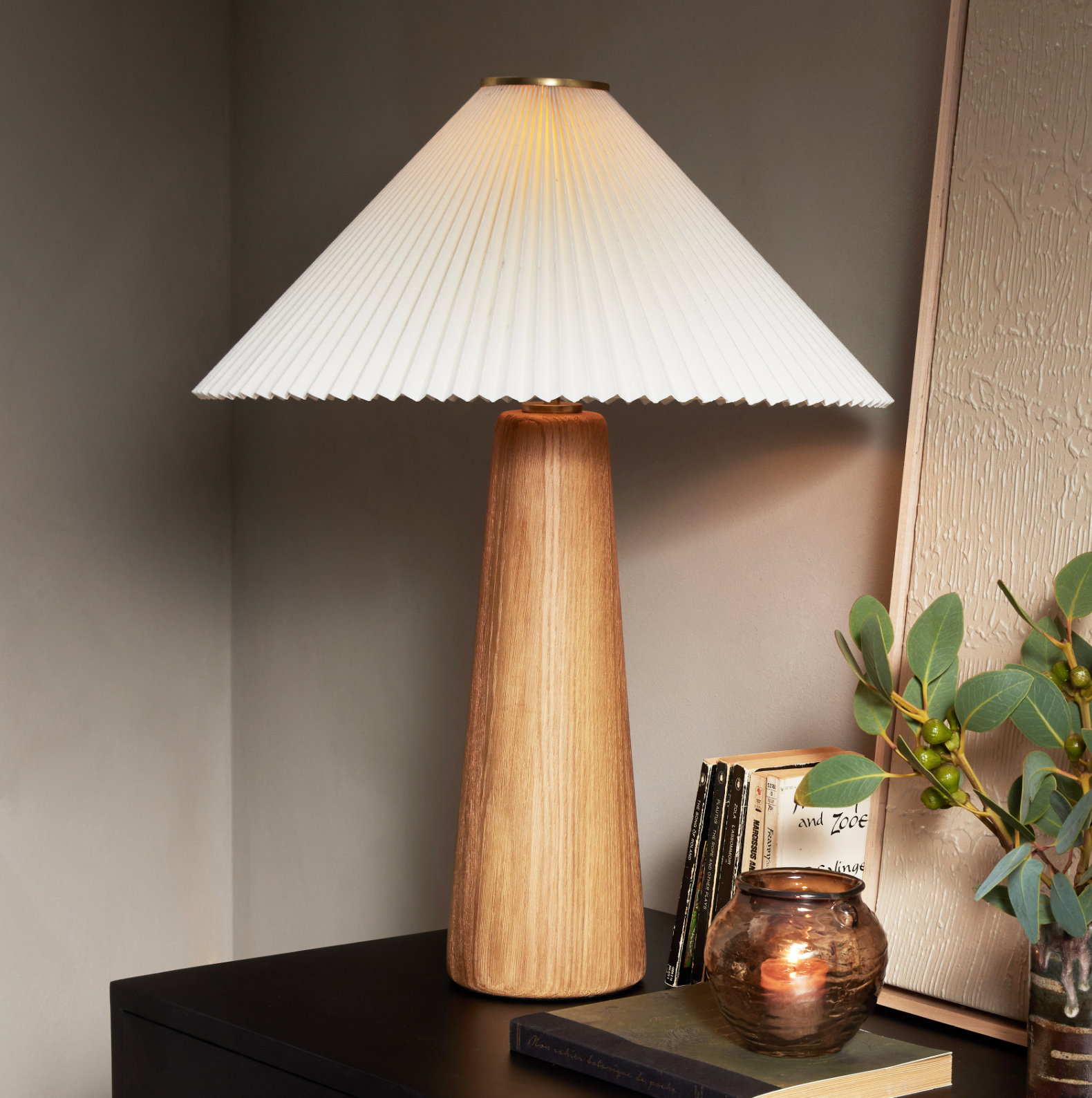Modern minimal meets traditional. A tapered wood table lamp base is topped with a design-forward pleated shade. Amethyst Home provides interior design, new home construction design consulting, vintage area rugs, and lighting in the Kansas City metro area.