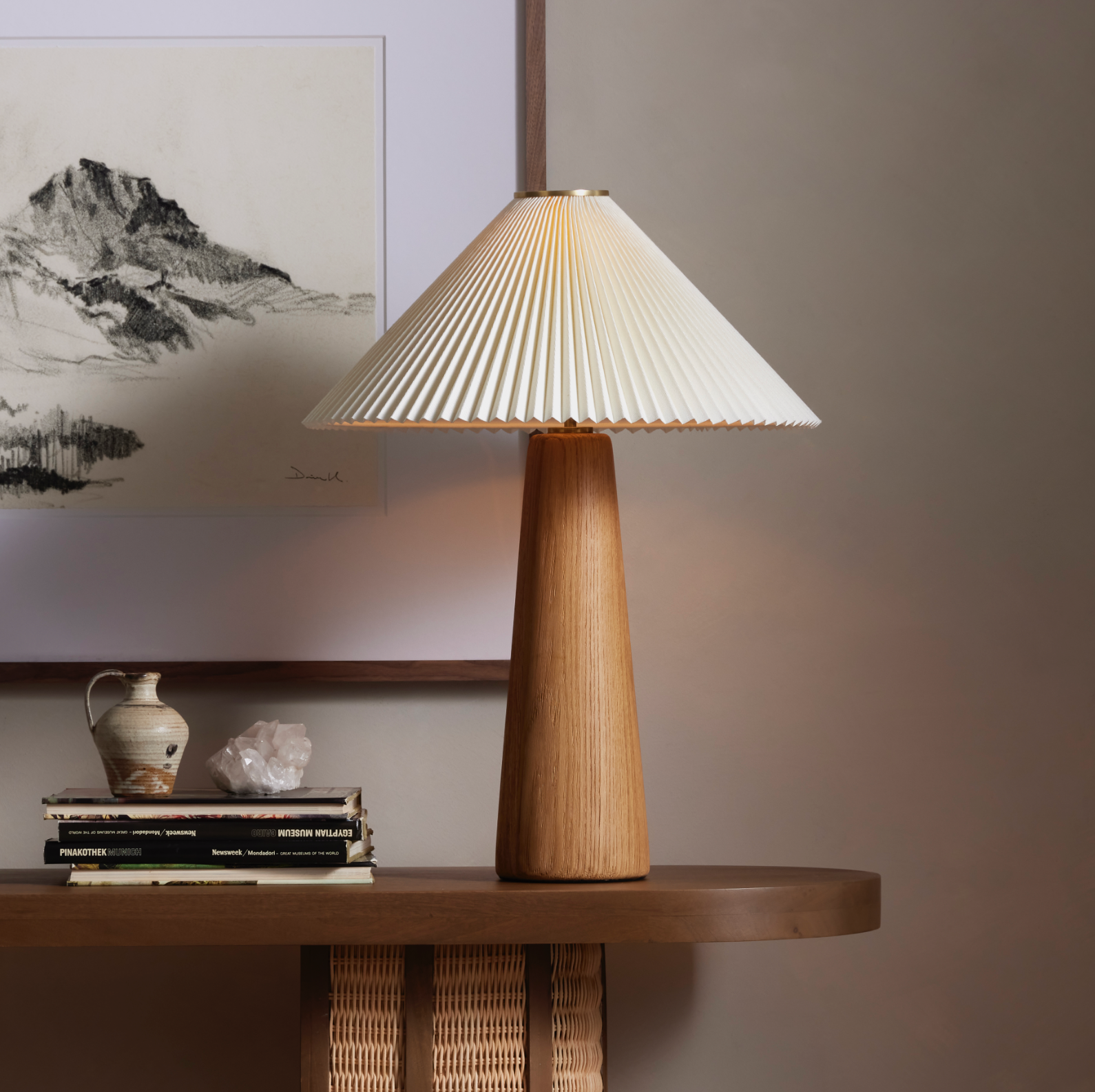 Modern minimal meets traditional. A tapered wood table lamp base is topped with a design-forward pleated shade. Amethyst Home provides interior design, new home construction design consulting, vintage area rugs, and lighting in the Raleigh metro area.