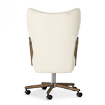 A comfort-driven desk chair features soft, textural upholstery, framed by solid ash arms. A height-adjustable swivel base with casters makes for ease in the modern office. Amethyst Home provides interior design, new home construction design consulting, vintage area rugs, and lighting in the Austin metro area.