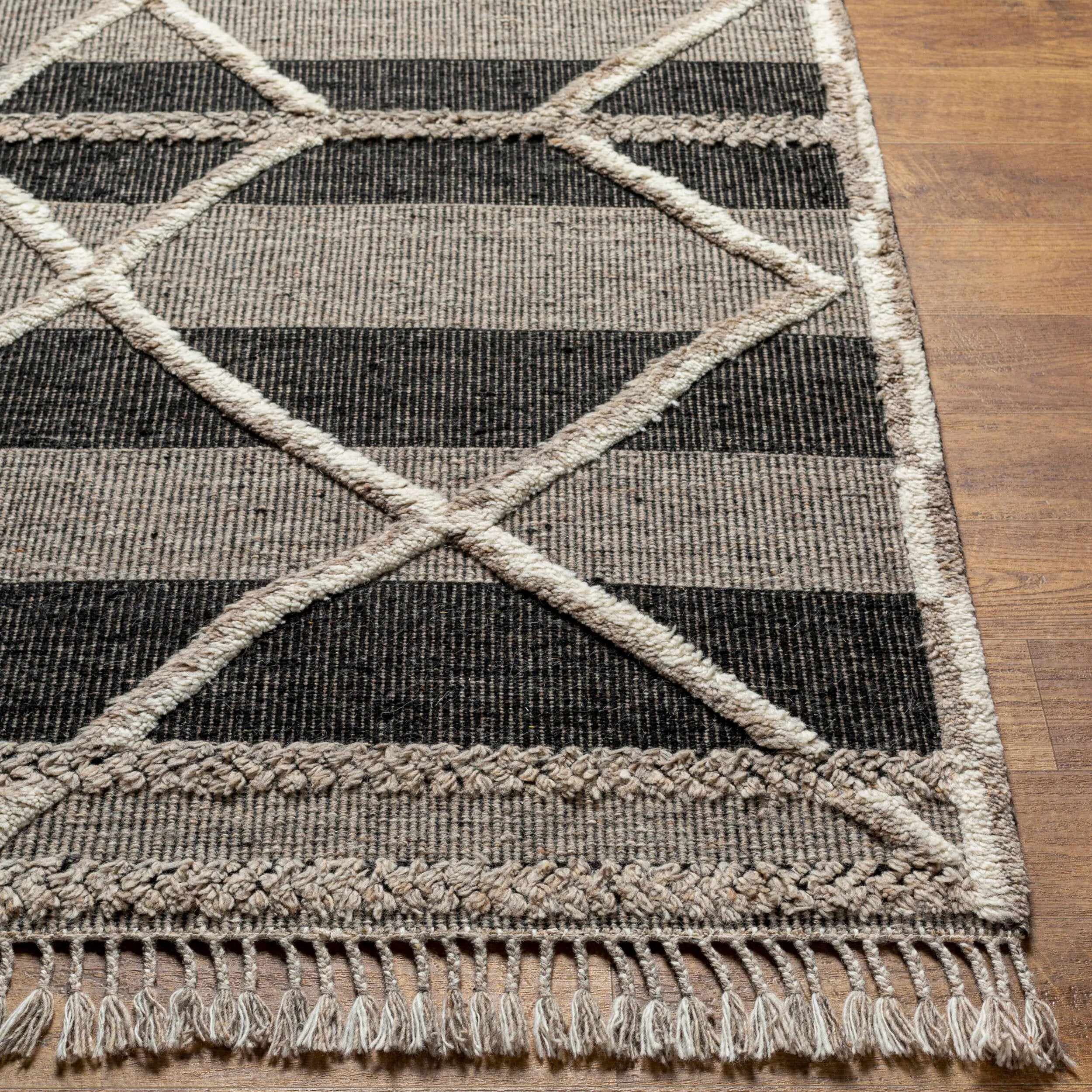 Bring a touch of global-inspired sophistication to your living space with the Cadiz Handmade Rug. This hand knotted wool rug has a plush pile, offering an inviting feel underfoot. The fringe detail adds texture and visual interest, while its Moroccan-style pattern gives this piece a timeless yet modern look. Amethyst Home provides interior design, new home construction design consulting, vintage area rugs, and lighting in the Nashville metro area.