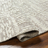 Introducing the Tunus Aubrey rug, hand-knotted from 100% wool and woven into an abstract, geometric pattern. Featuring taupe and ivory colors, this stylish and warm rug brings modern sophistication to any space. Amethyst Home provides interior design, new home construction design consulting, vintage area rugs, and lighting in the Alpharetta metro area.