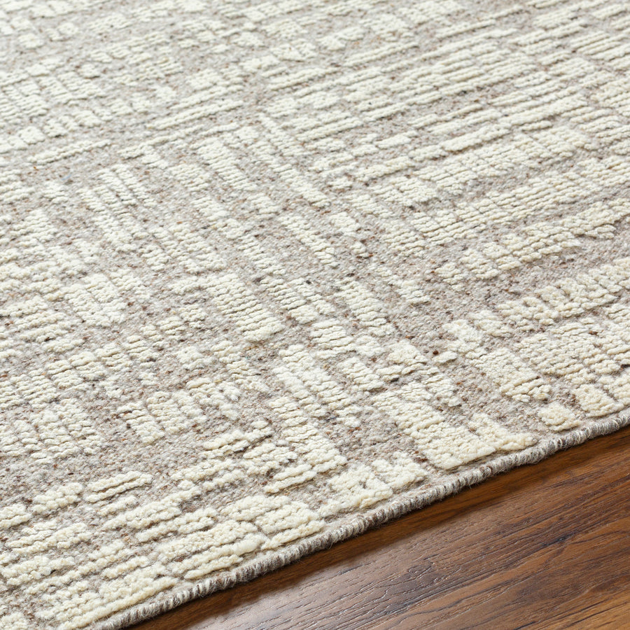 Introducing the Tunus Aubrey rug, hand-knotted from 100% wool and woven into an abstract, geometric pattern. Featuring taupe and ivory colors, this stylish and warm rug brings modern sophistication to any space. Amethyst Home provides interior design, new home construction design consulting, vintage area rugs, and lighting in the Park City metro area.