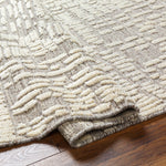Introducing the Tunus Molly rug, hand-knotted from 100% wool and woven into an abstract, geometric pattern. Featuring taupe and ivory colors, this stylish and warm rug brings modern sophistication to any space. Amethyst Home provides interior design, new home construction design consulting, vintage area rugs, and lighting in the Tampa metro area.
