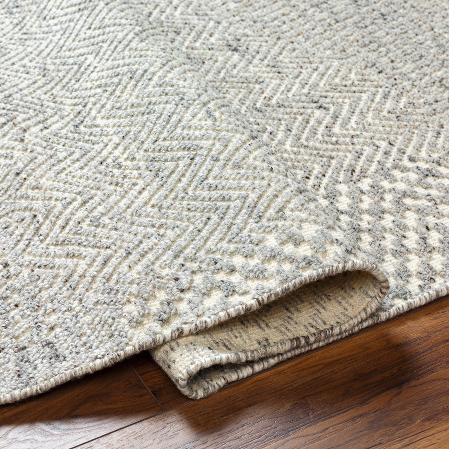 The Tunus Pewter Rug features a globally inspired design made from wool. The hand-knotted rug adds wabi sabi charm to any room. Amethyst Home provides interior design, new home construction design consulting, vintage area rugs, and lighting in the Des Moines metro area.