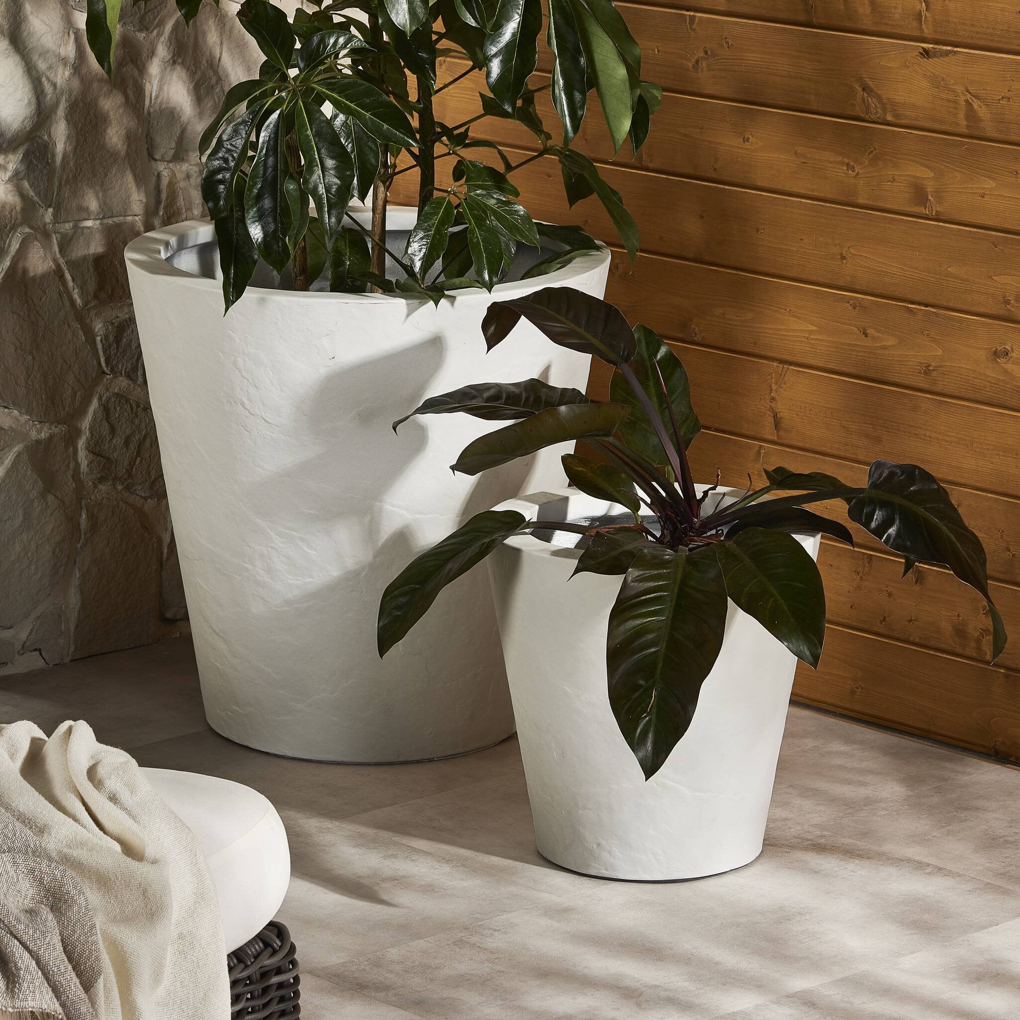 Featuring Suvi Textured White Concrete Planter by Four Hands at Amethyst Home. Textured white concrete forms a minimalist, tapered planter for a wide range of spaces. Cover or store indoors during inclement weather and when not in use.Overall Dimensions: 18.00"w x 18.00"d x 18.00"hWeight : 40.56 lbsMaterials : Concrete. Amethyst Home provides interior design, new construction, custom furniture, and area rugs in the Park City metro area