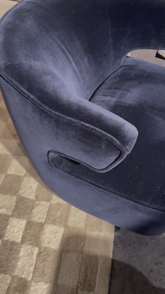 The continuous form of this swivel chair creates a sleek look that elevates everyday seating. Upholstered in navy wool blend, its sleek design is complemented by a 360-degree swivel and pedestal base of solid parawood for a mixed media moment.Overall Dimensions: 29.00"w x 33.75"d x 27.25"h Amethyst Home provides interior design, new home construction design consulting, vintage area rugs, and lighting in the Alpharetta metro area.