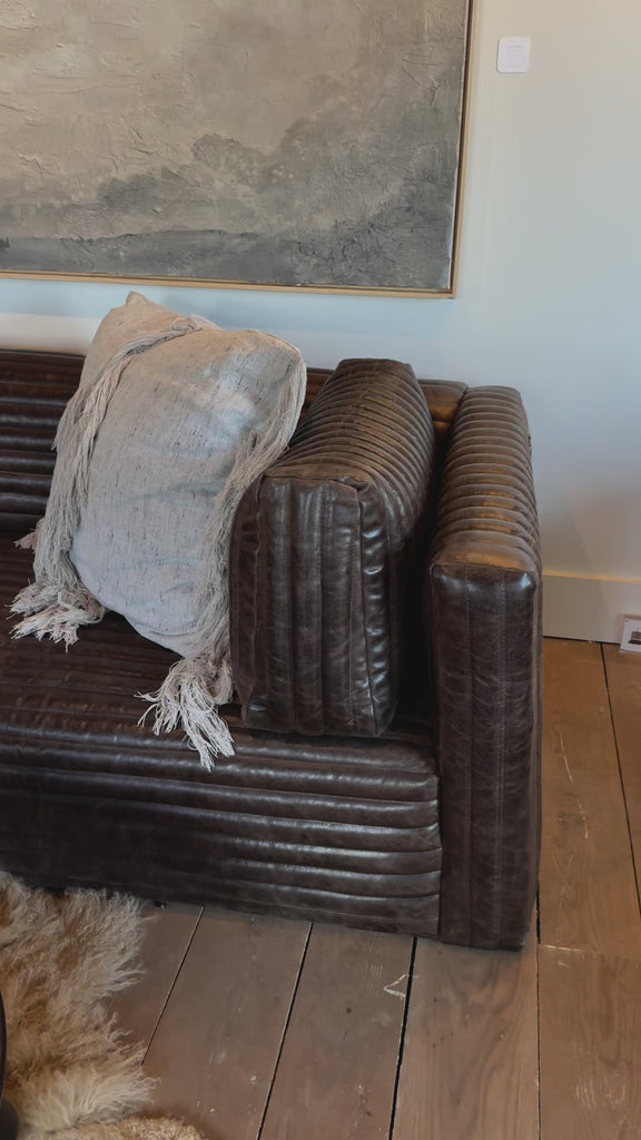 The Clemence Sofa features a minimalist design with clean, low-profile lines, complemented by plush cushions and luxurious throw pillows. Amethyst Home provides interior design, new home construction design consulting, vintage area rugs, and lighting in the Seattle metro area.