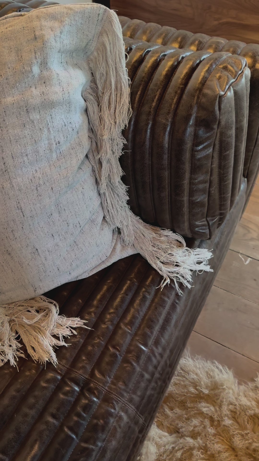 The Clemence Sofa features a minimalist design with clean, low-profile lines, complemented by plush cushions and luxurious throw pillows. Amethyst Home provides interior design, new home construction design consulting, vintage area rugs, and lighting in the Charlotte metro area.