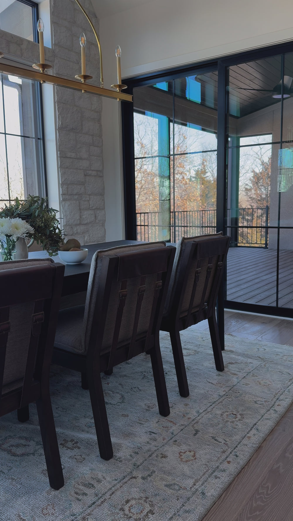 An Amethyst fave -- the Wilmington dining chair has a gorgeous coffee colored textile paired with medium toned wood and interesting leather buckles on the back -- we tied in the gold buckles with the gold chandelier above!  Inspired by the folded pillow form, the seat and back cushions of this parawood dining chair are covered in performance fabric. Amethyst Home provides interior design, new home construction design consulting, vintage area rugs, and lighting in the Omaha metro area.