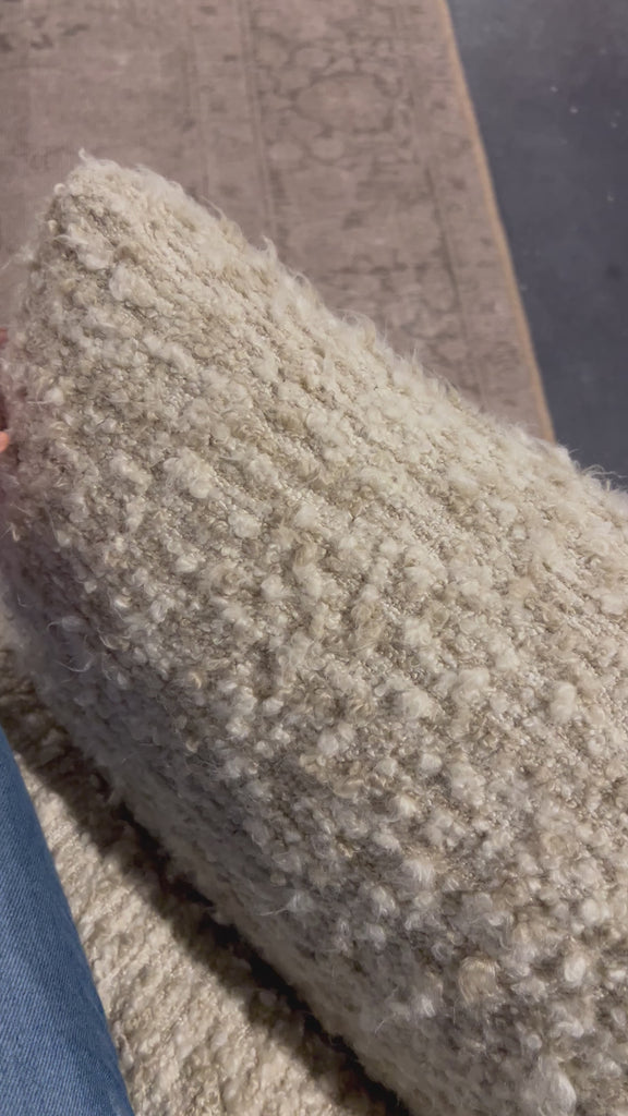 A modern take on a 70s-inspired shape. This sink-in, pillow-like chair features S-spring suspension for extra comfort and durability in the seat, all on a 360-degree swivel. Upholstered in an exaggerated boucle fabric with extra depth and texture throughout. Amethyst Home provides interior design, new home construction design consulting, vintage area rugs, and lighting in the Scottsdale metro area.