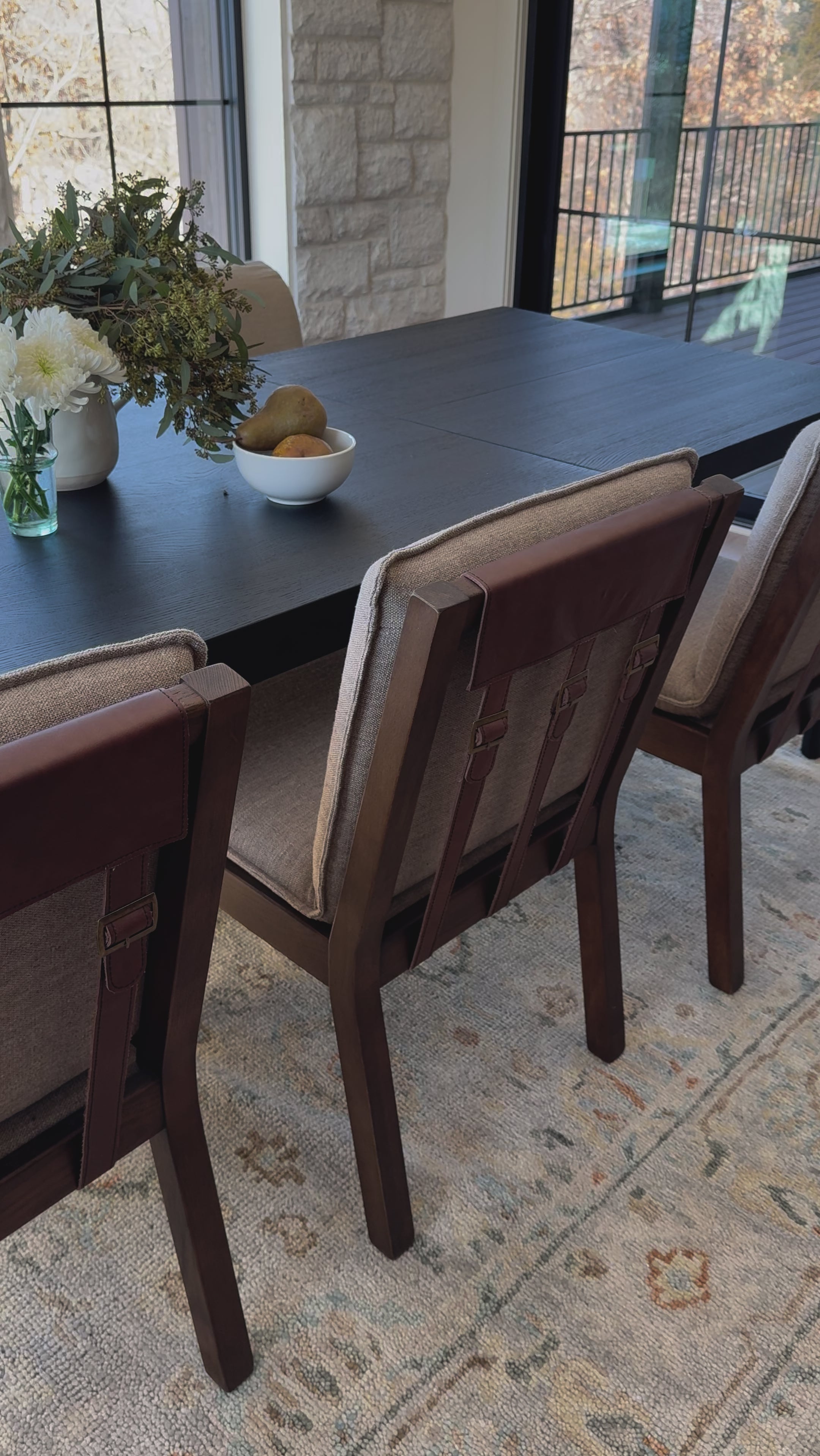 An Amethyst fave -- the Wilmington dining chair has a gorgeous coffee colored textile paired with medium toned wood and interesting leather buckles on the back -- we tied in the gold buckles with the gold chandelier above!  Inspired by the folded pillow form, the seat and back cushions of this parawood dining chair are covered in performance fabric. Amethyst Home provides interior design, new home construction design consulting, vintage area rugs, and lighting in the Austin metro area.