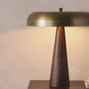 A stylish nod to midcentury mushroom lamps, this beautifully scaled wooden lamp features a gleaming metal shade finished in aged brass. It's topped with a small wood finial to complete the look.Overall Dimensions: 20.00"w x 20.00"d x 22.75"hWeight : 15.78 lbsMaterials : Solid Mango, Iron Amethyst Home provides interior design, new home construction design consulting, vintage area rugs, and lighting in the Nashville metro area.