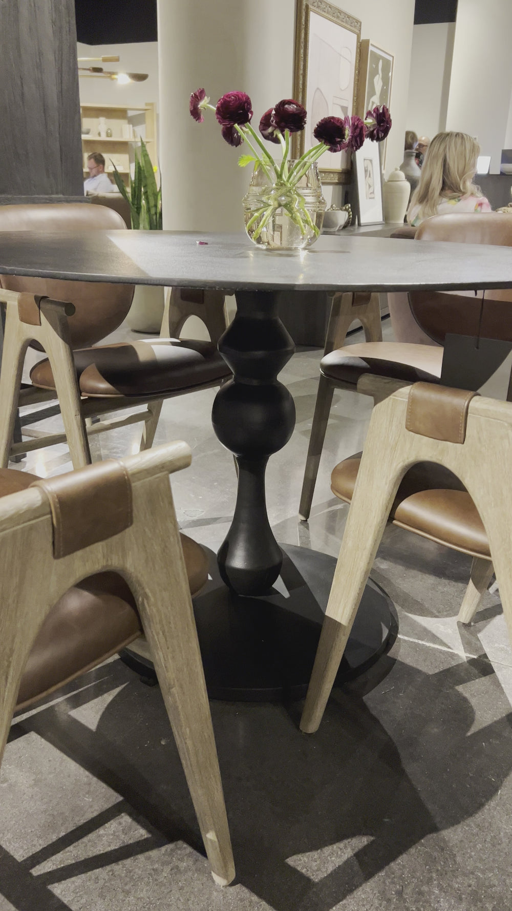 Finished in an antique black, raw aluminum shapes a bistro-style dining table with a turned, geometric look. Seats four comfortably. Amethyst Home provides interior design, new home construction design consulting, vintage area rugs, and lighting in the Winter Garden metro area.