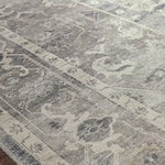 Featuring soft motifs in a carefully curated color palate of grey, black, ivory and hints of blue, the Hathaway Steel / Ivory area rug captures the essence of one-of-a-kind vintage or antique area rug at an attractive price.